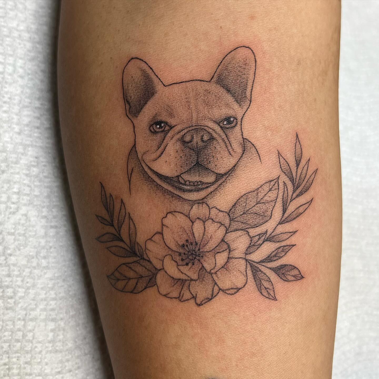 French bulldog with flowers realism tattoo on the forearm by Ana Valadez π¦, Ventura, California