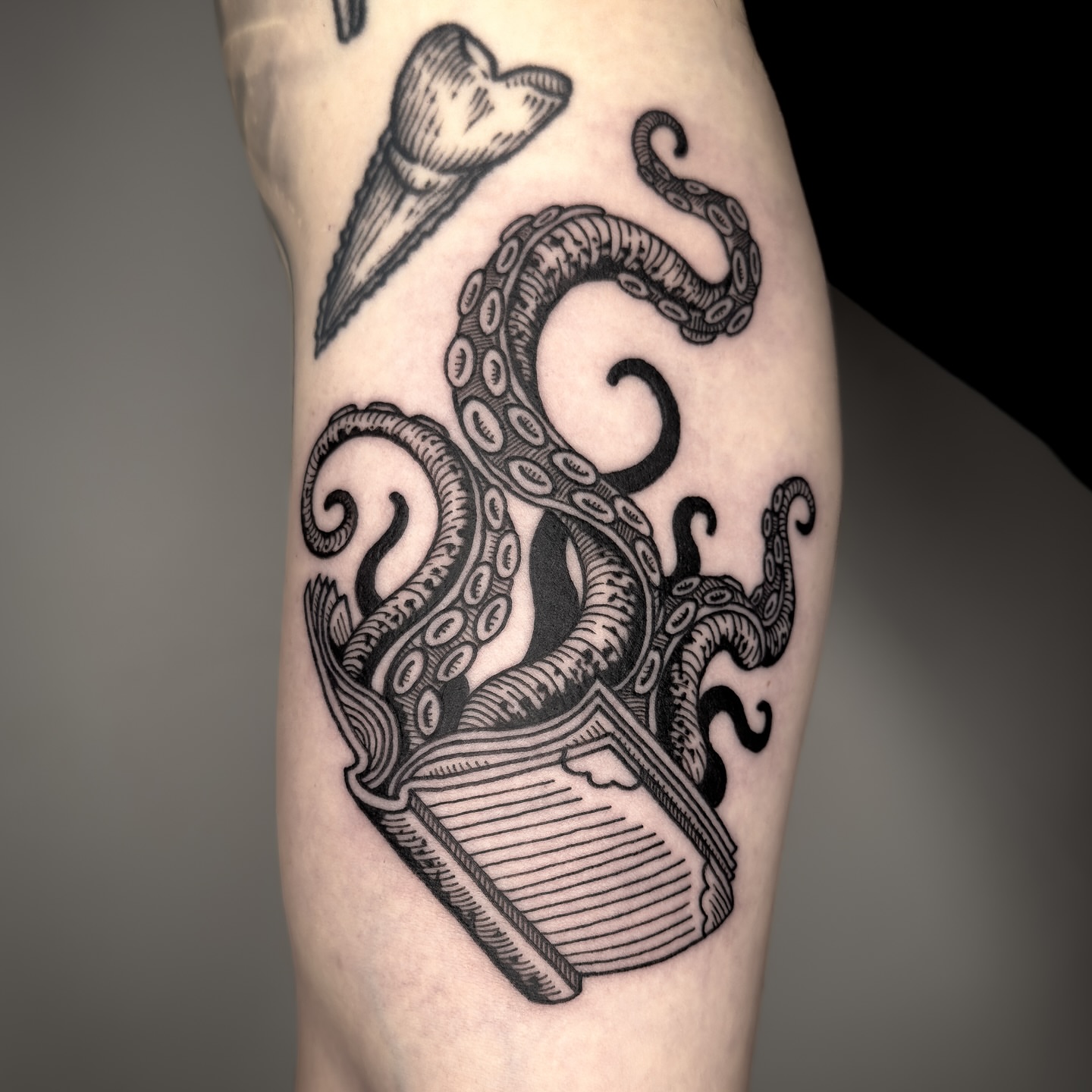 Octopus and book black and grey tattoo on the forearm by Dokk