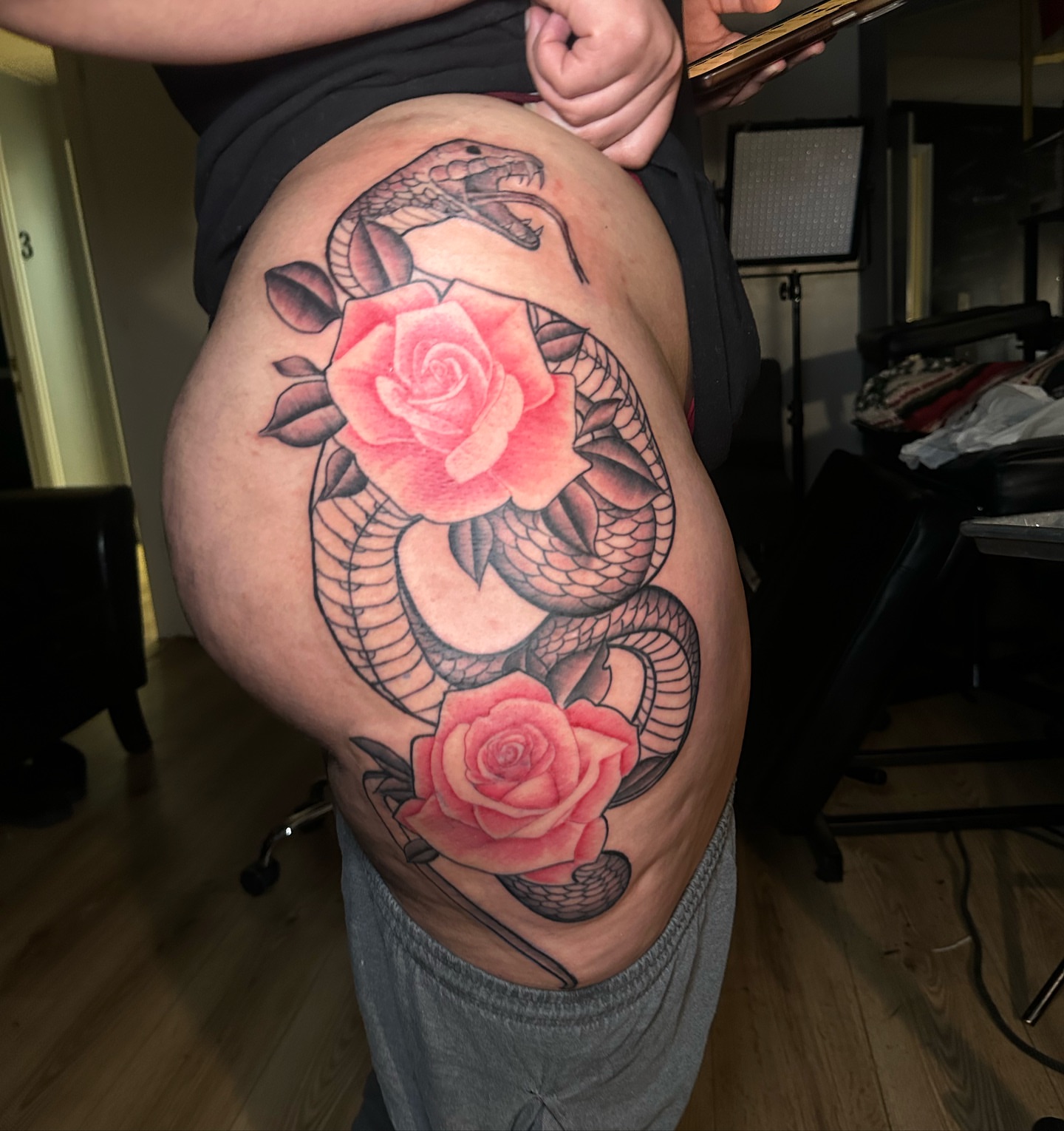 Snake and roses American traditional tattoo on the thigh by @tattedbytuck