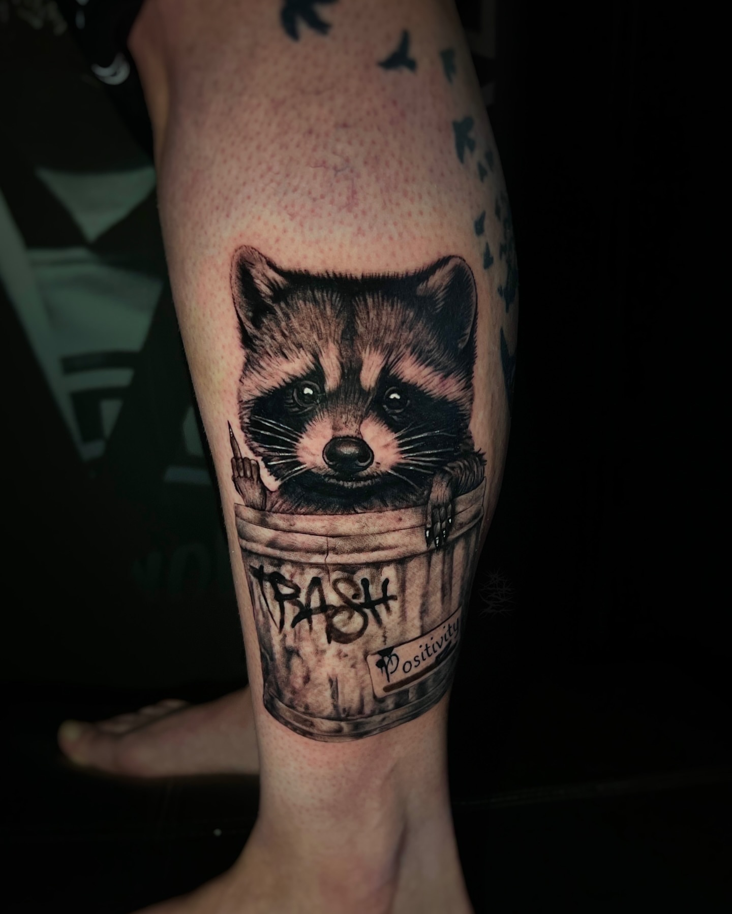 Raccoon in trash can realism tattoo on the forearm by Matthew Diaz