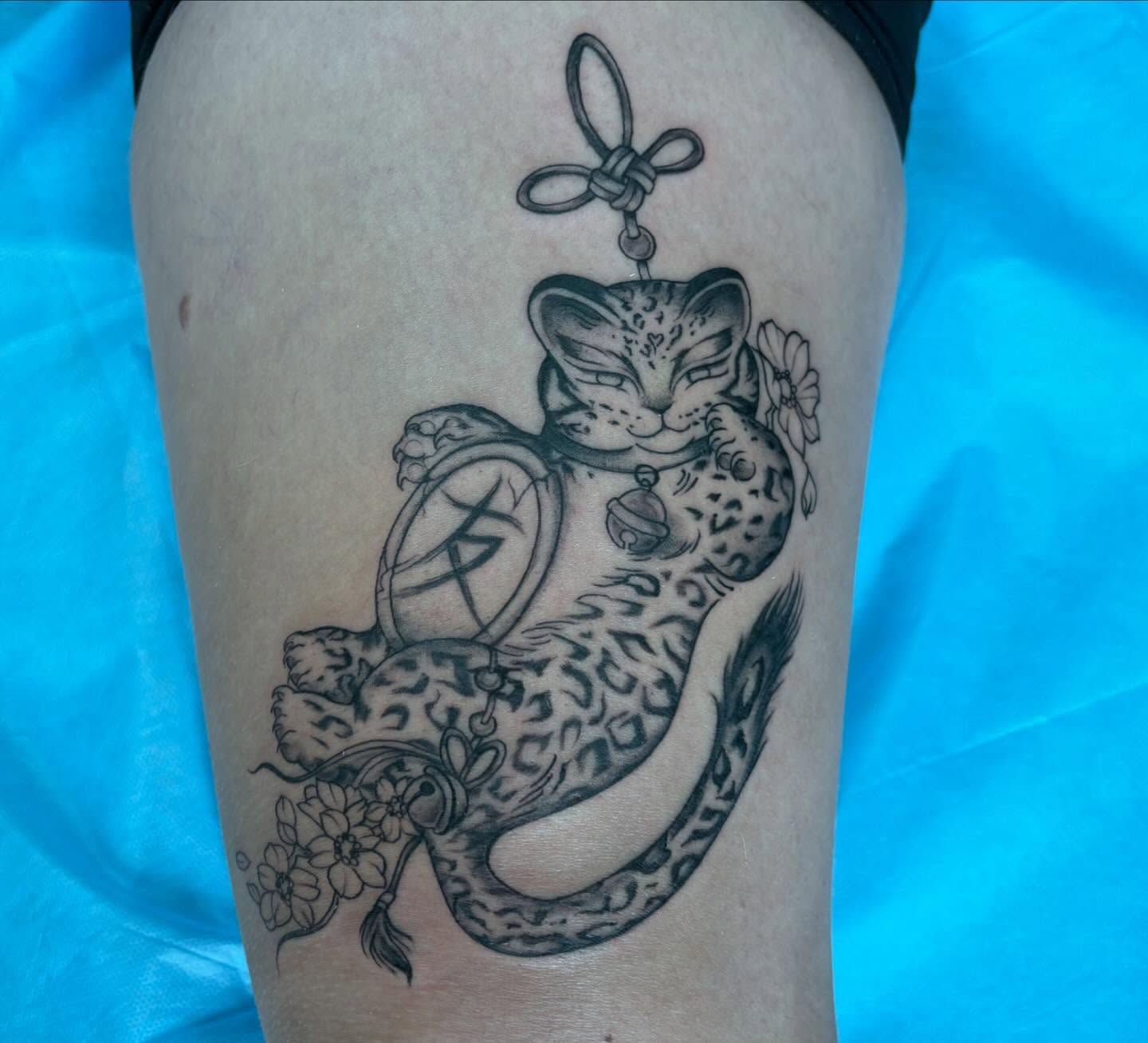 Leopard and lantern realism tattoo on the thigh by Ivanna