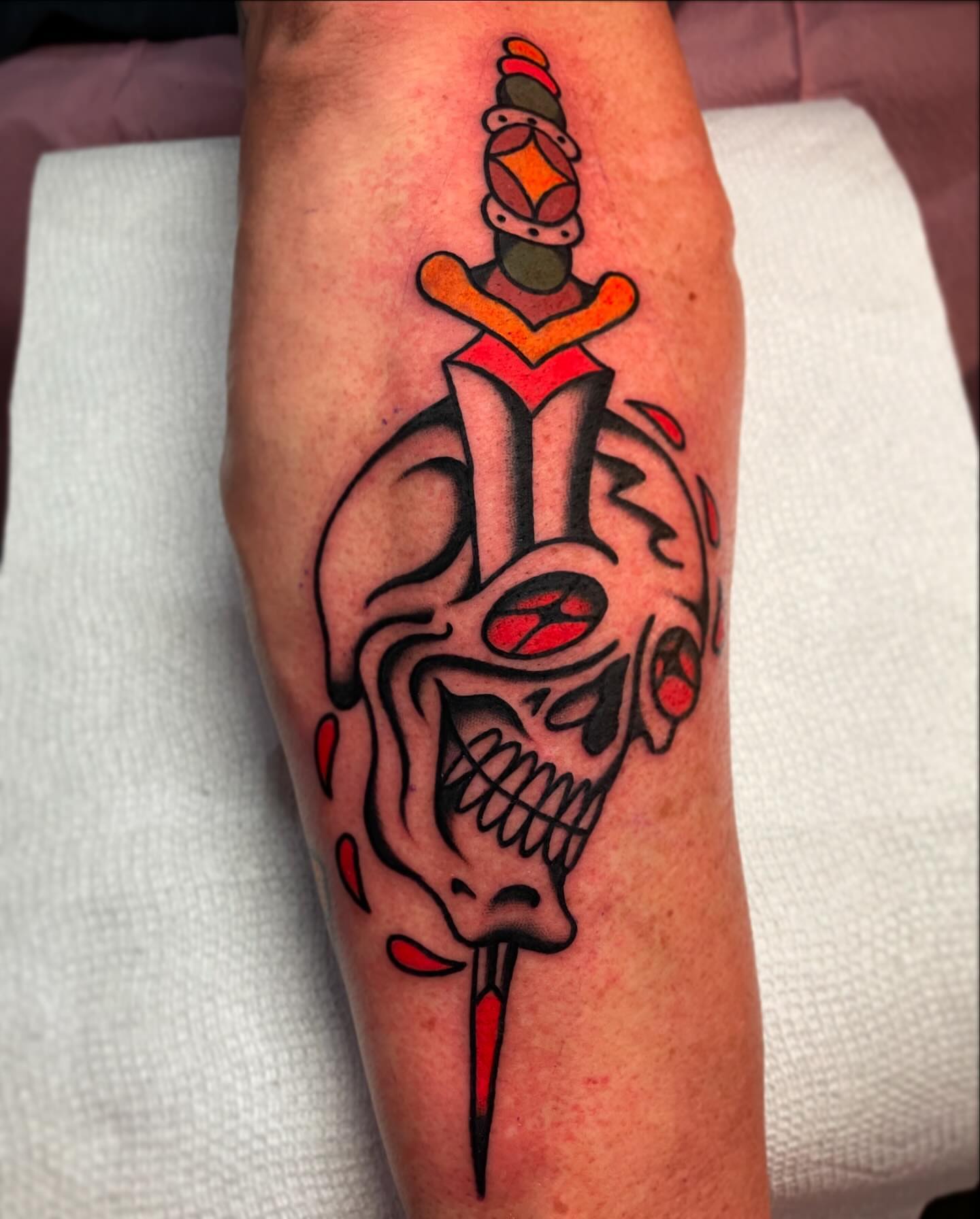 Skull with dagger American traditional tattoo on the forearm by Jacob, Marion, Illinois