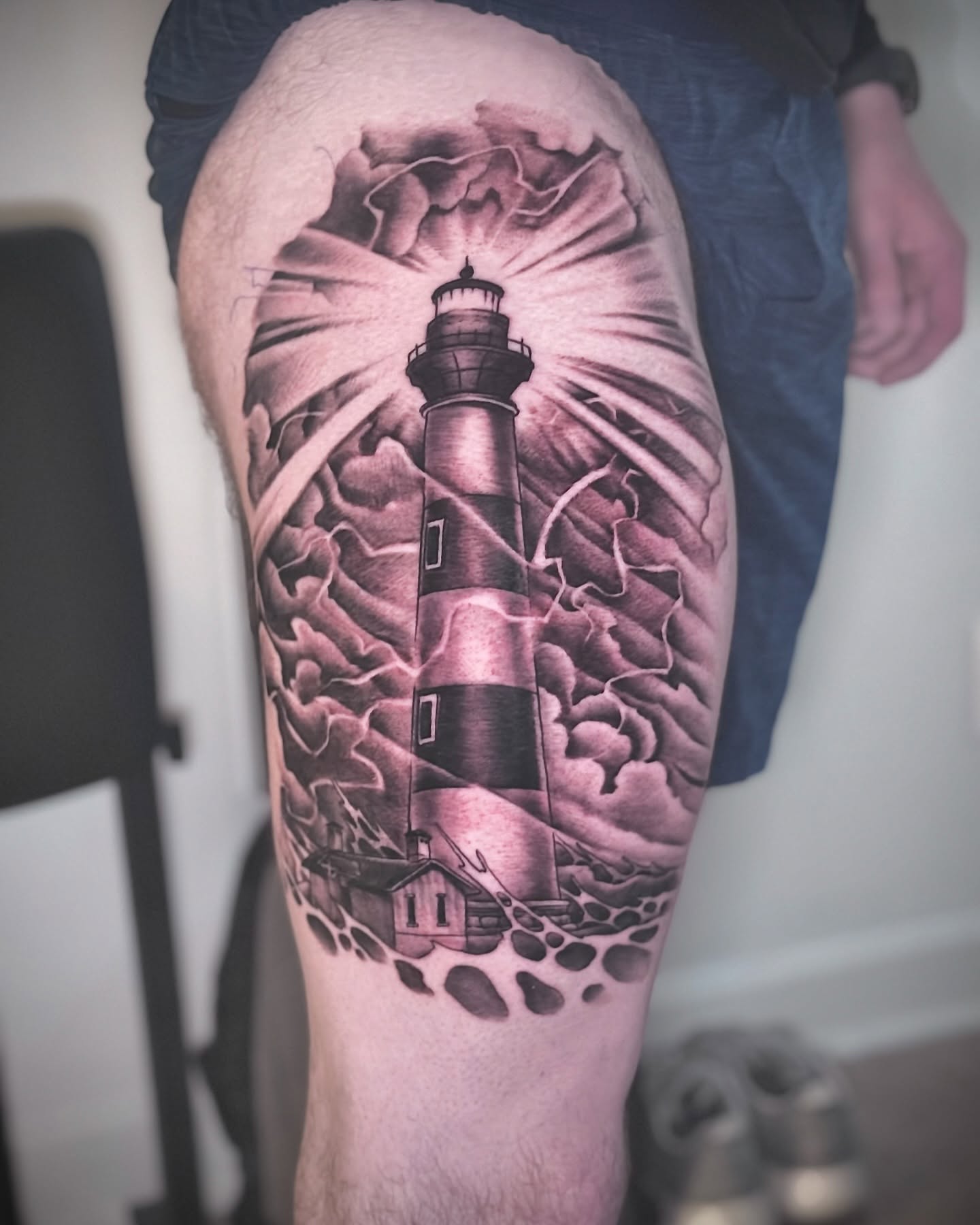 Lighthouse realism tattoo on the thigh by Matti Hixson