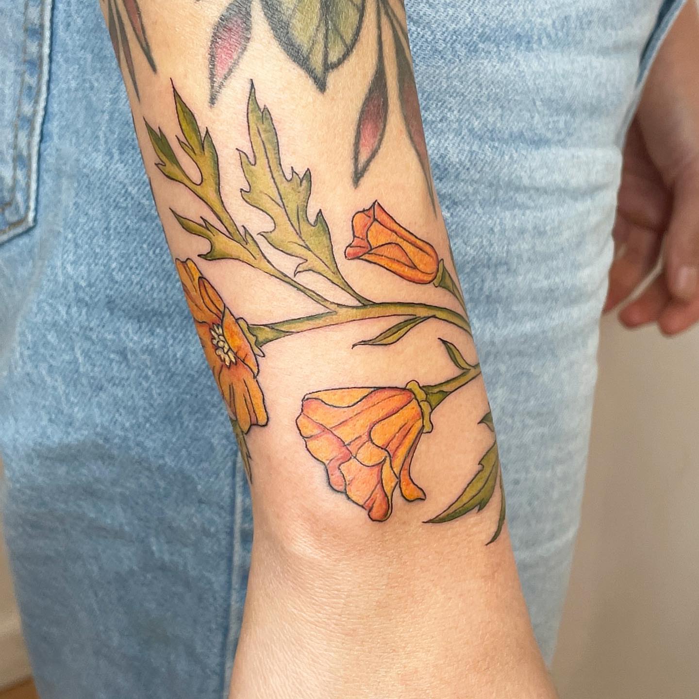 Flowers watercolor tattoo on the forearm by Reba Slate
