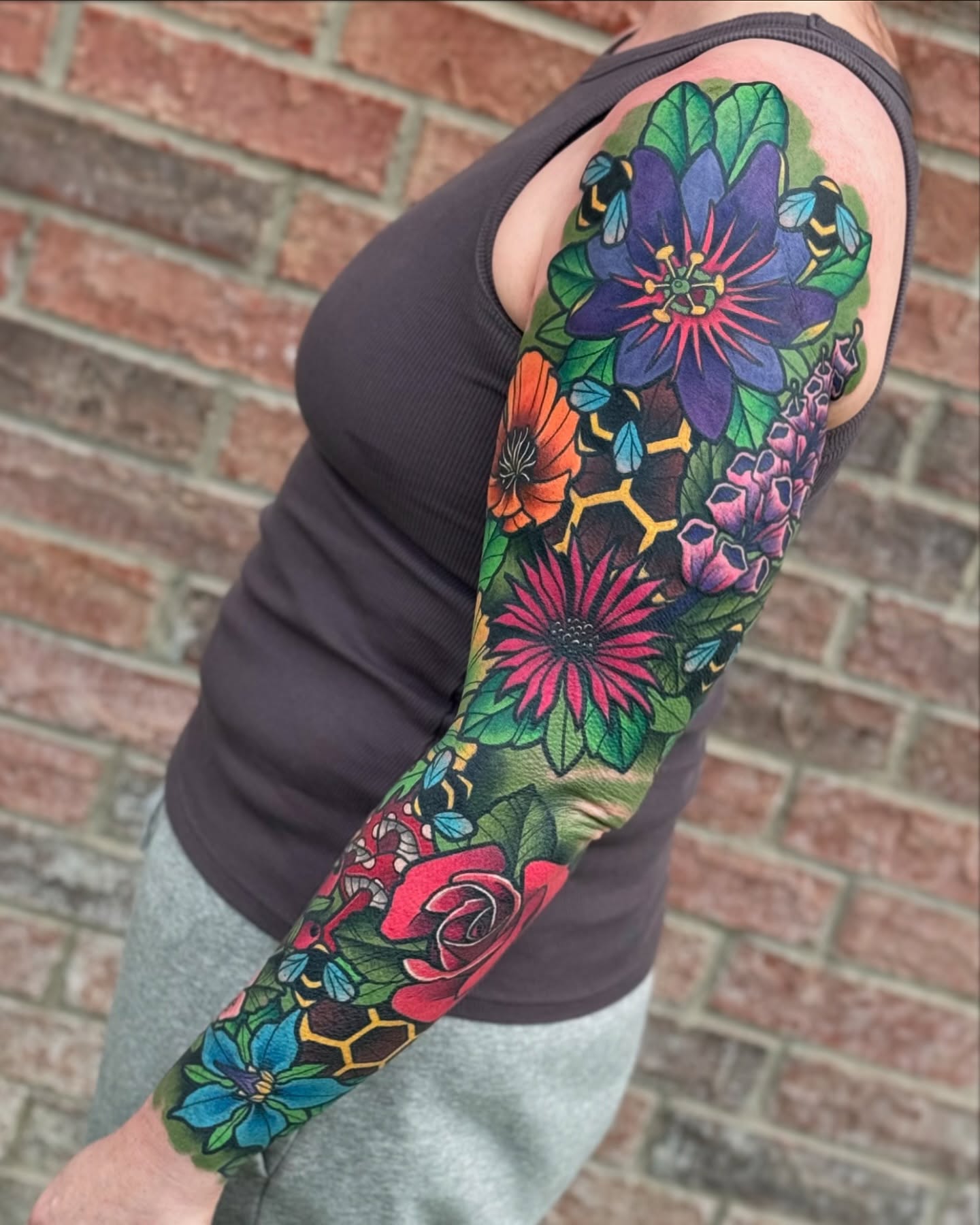 Floral bouquet American traditional tattoo on the upper arm by T Dubs ✏️
