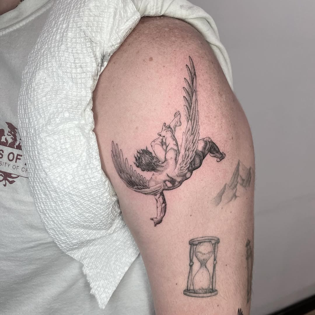 Falling angel realism tattoo on the upper arm by Jesus A.