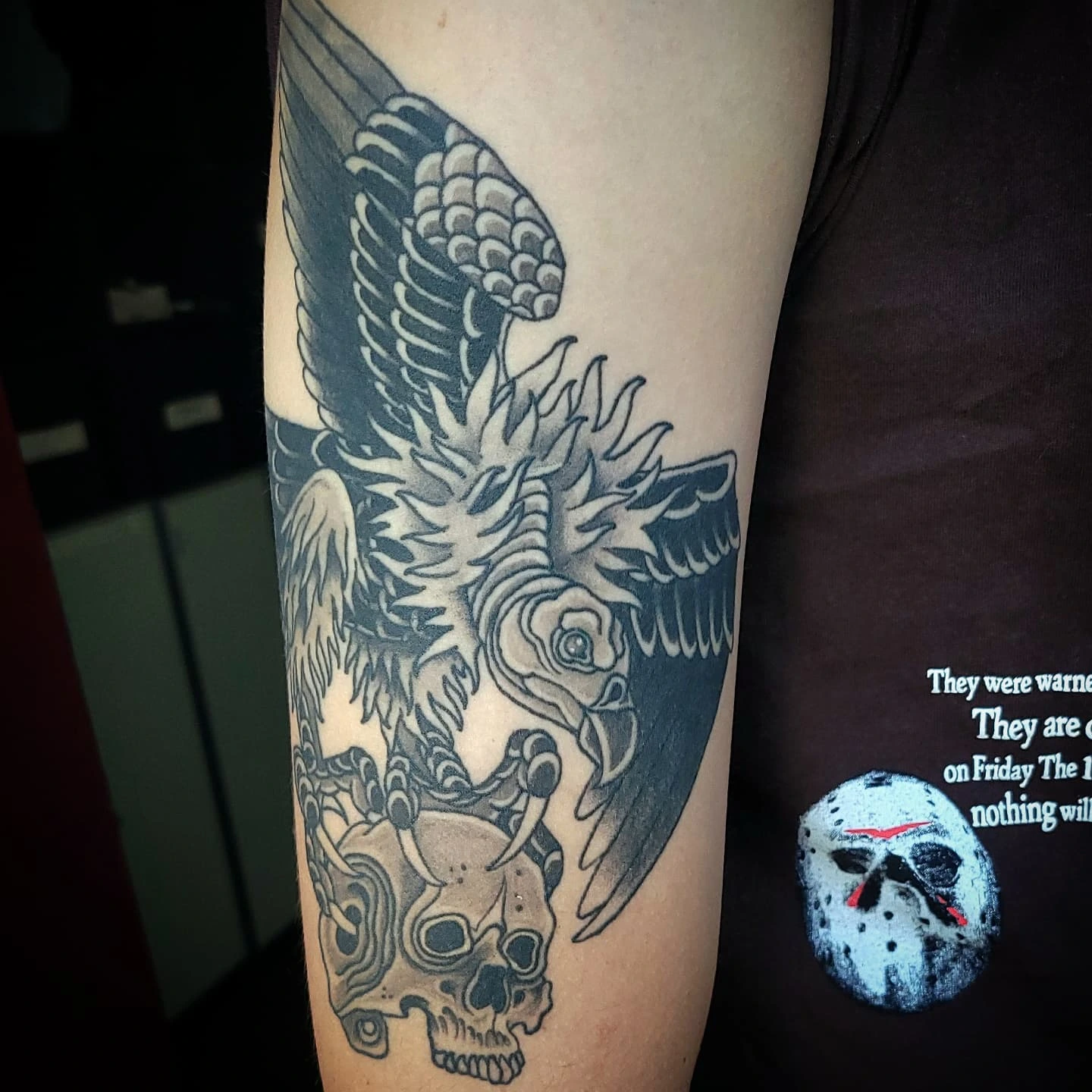 Winged creature and skull American traditional tattoo on the forearm by Sean Hollinger
