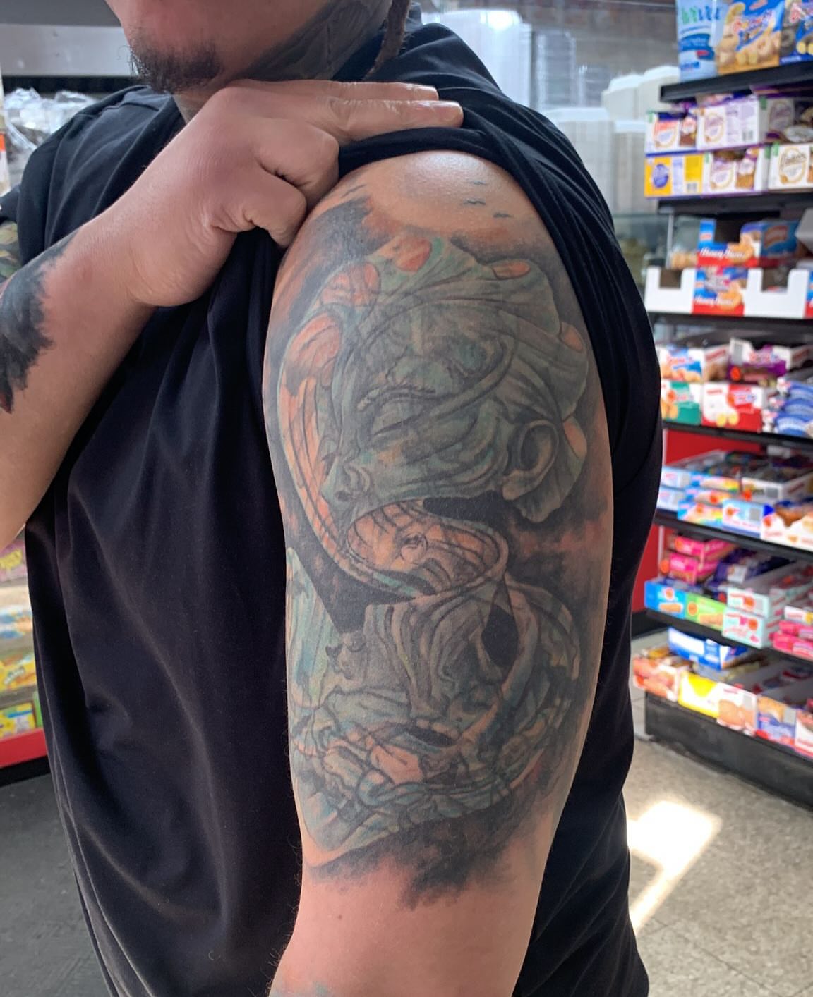 Woman with dragon realism tattoo on the upper arm by Bruno Marx