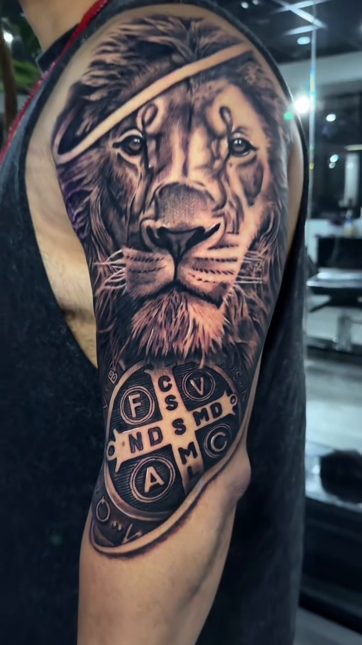 Lion and St. Benedict medal realism tattoo by Rafa