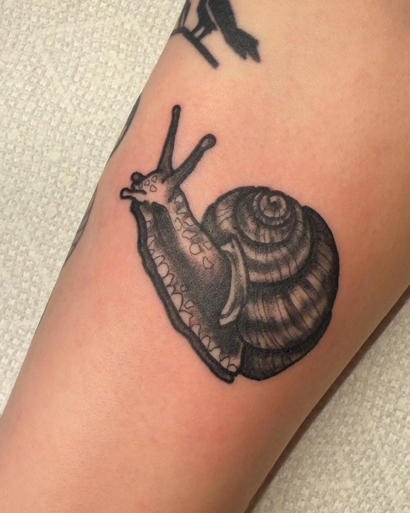 Snail black and grey tattoo on the forearm by G. Clover ⚧︎, Chicago, Illinois