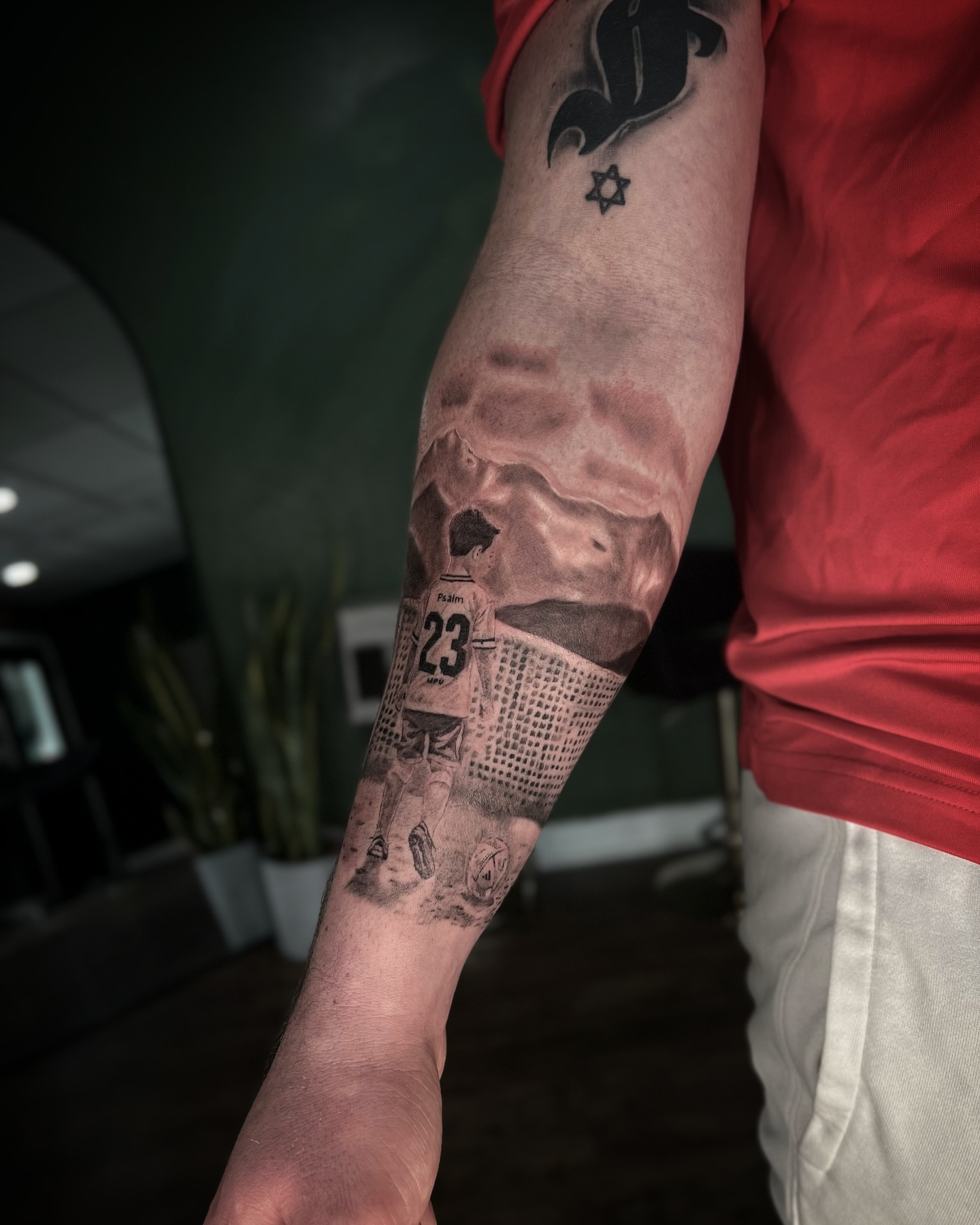 Soccer player realism tattoo on the forearm by Romi Utah Tattoo