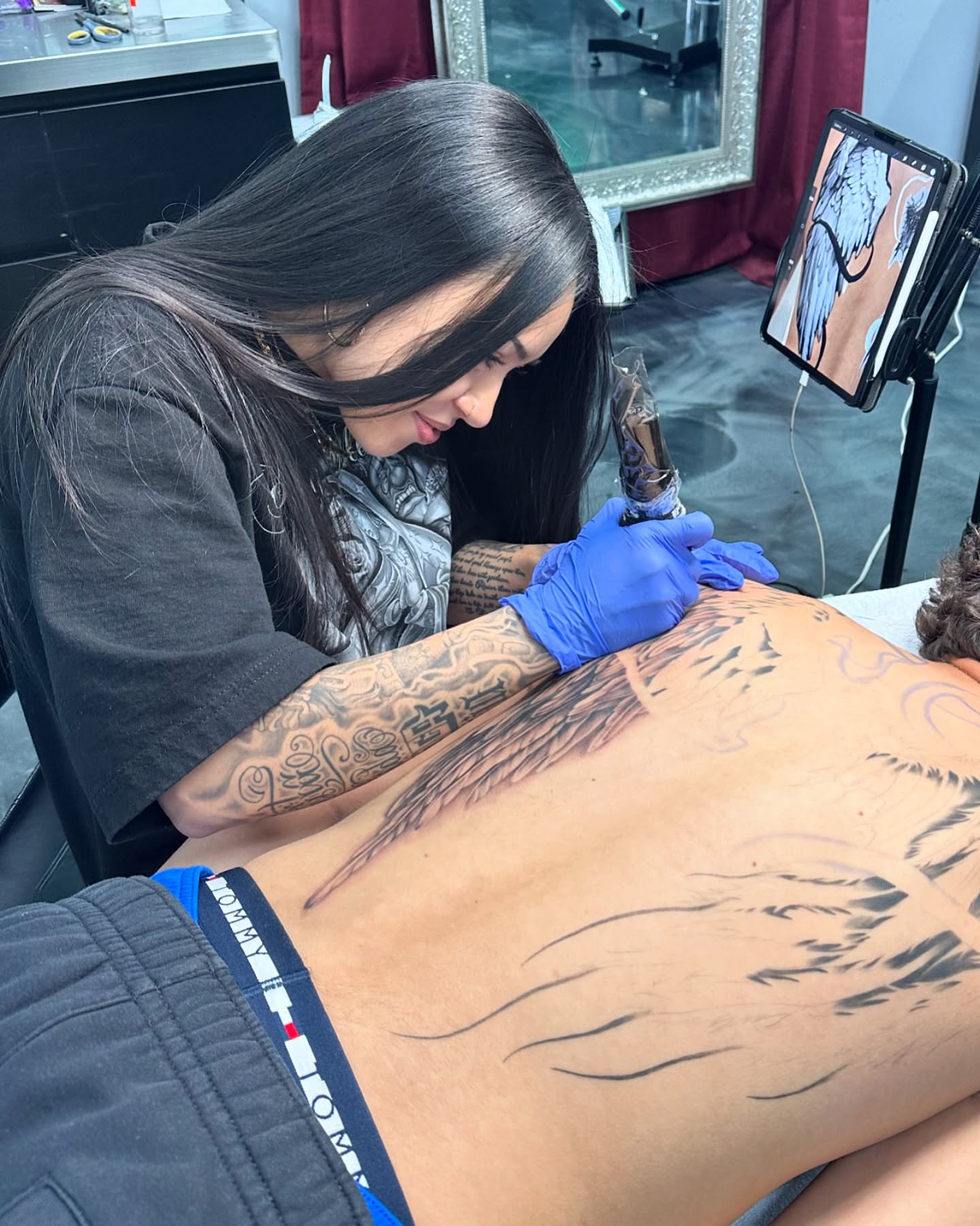 Bird black and grey tattoo on the back by Dani B.