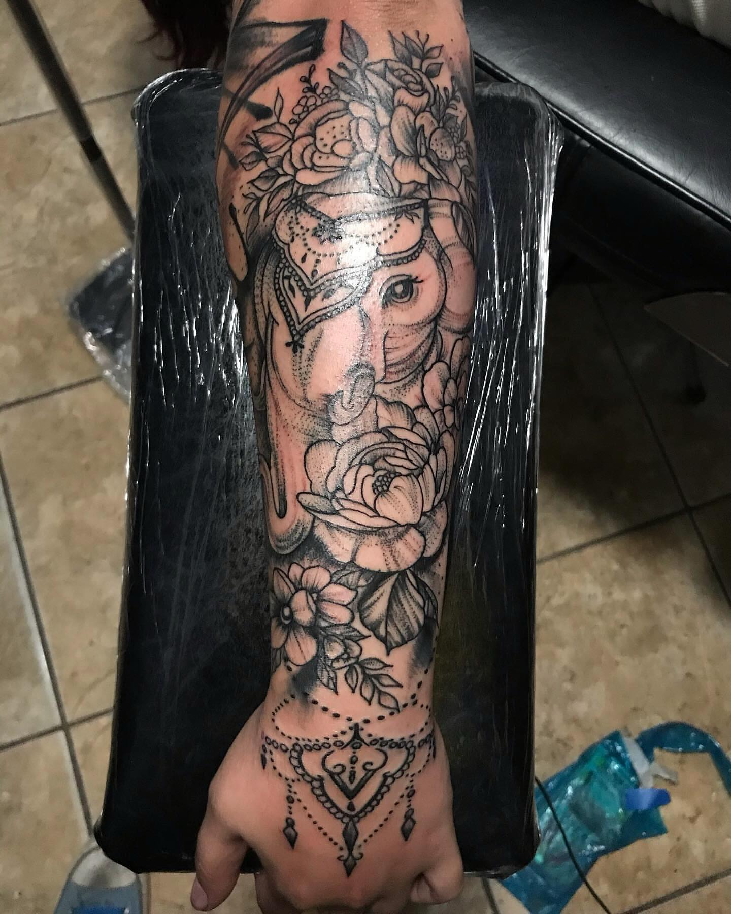 Elephant and floral dotwork tattoo on the forearm by Tonii Florrez