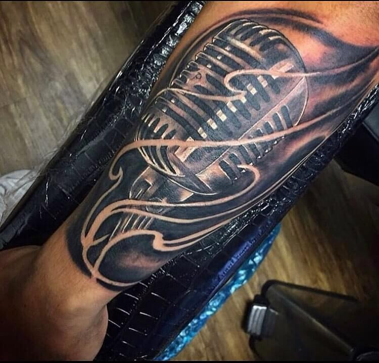 Microphone black and grey tattoo on the forearm by Tonii Florrez
