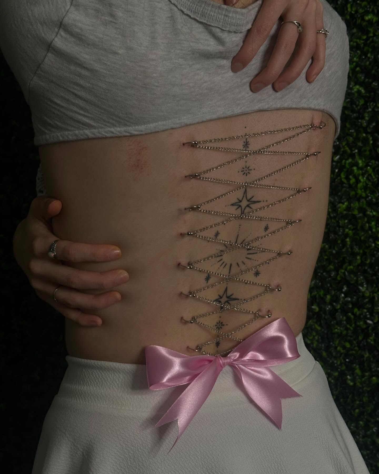 Corset geometric tattoo on the torso by Zoie Stiles
