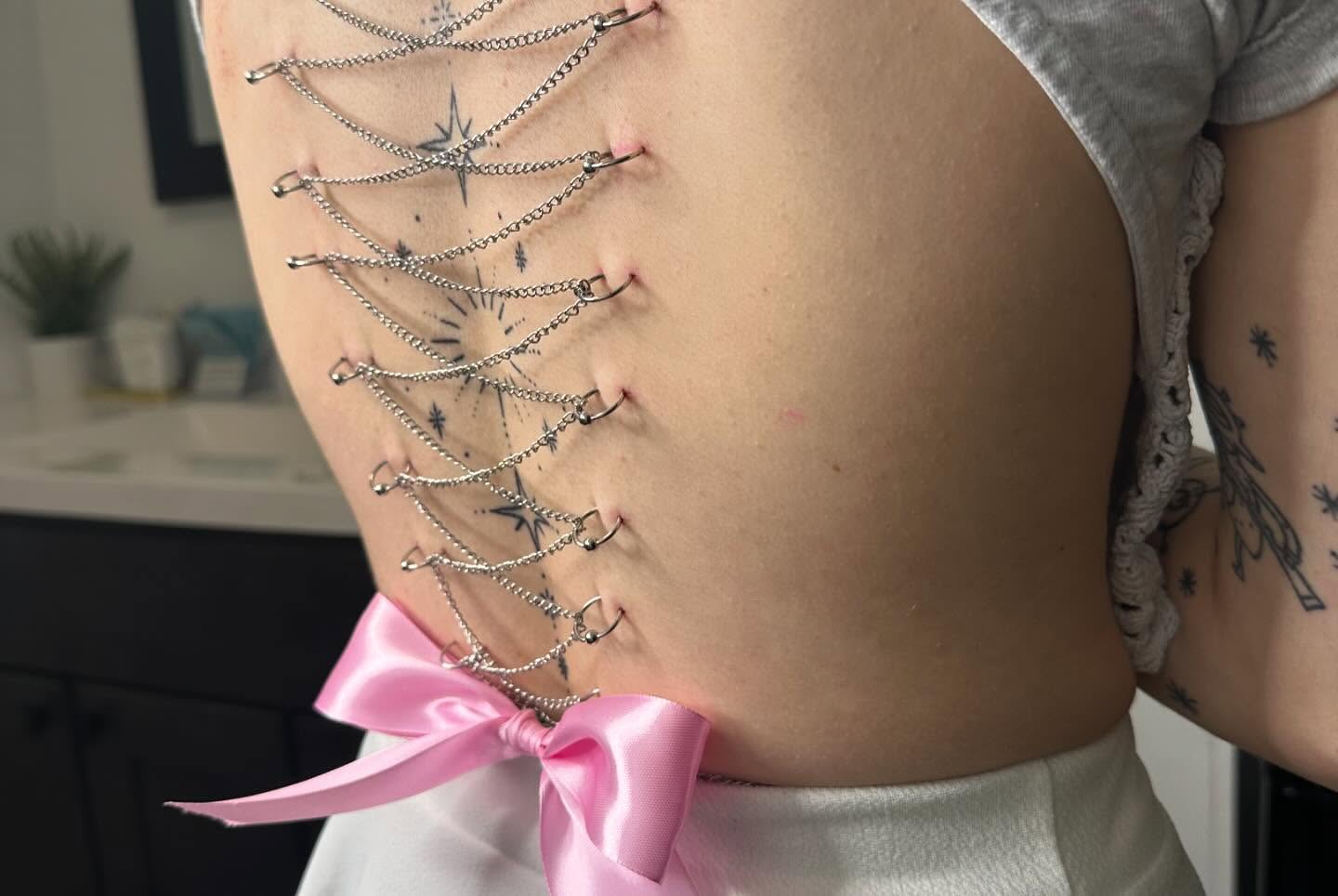 Corset geometric tattoo on the torso by Zoie Stiles