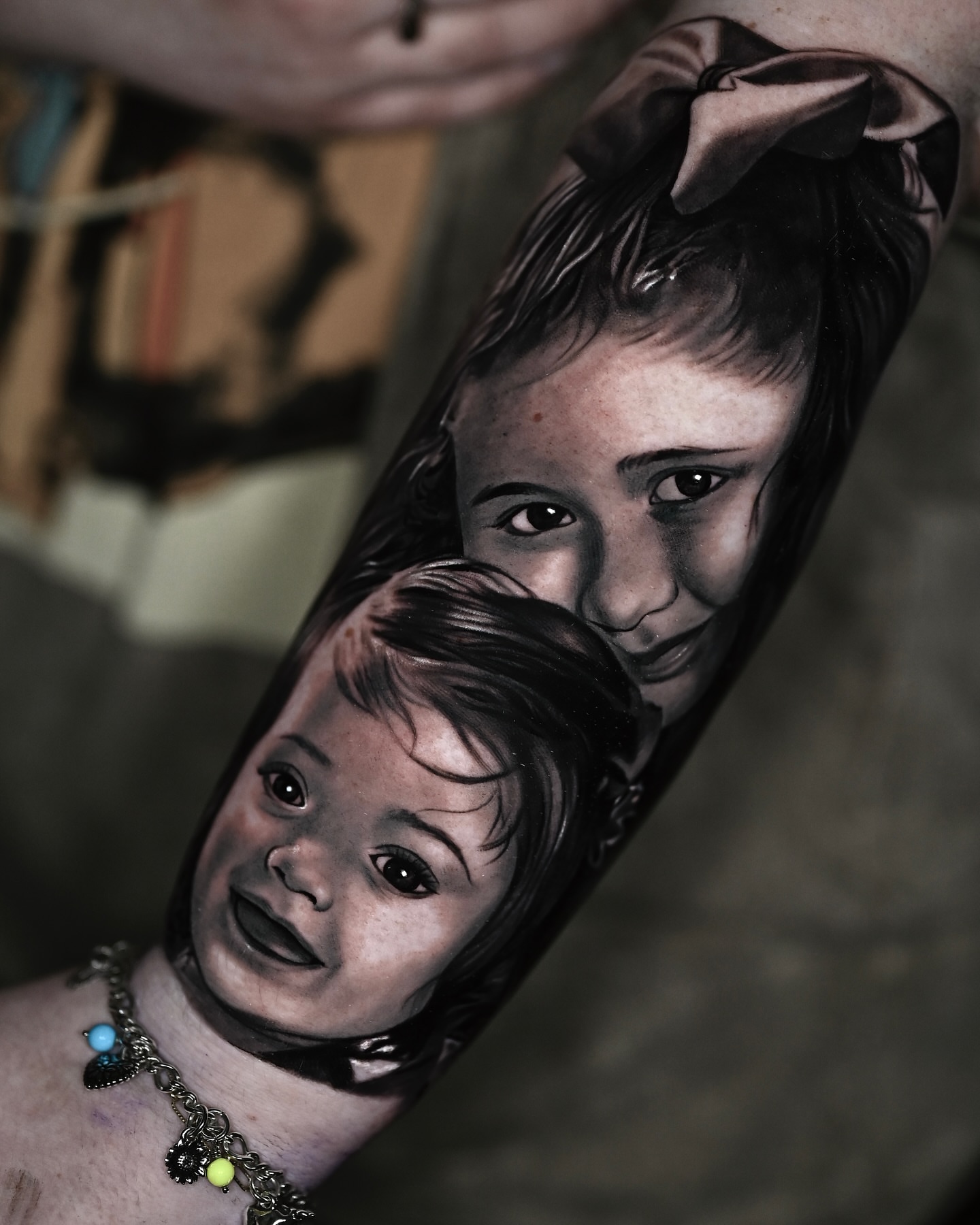 Child portrait realism tattoo on the forearm by Marcos Salamanca