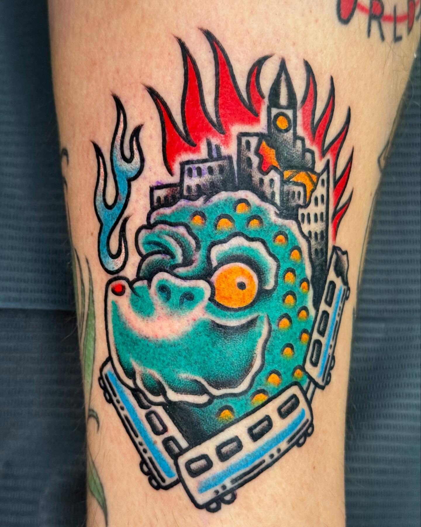 Film strip with cityscape American traditional tattoo on the forearm by Big Al