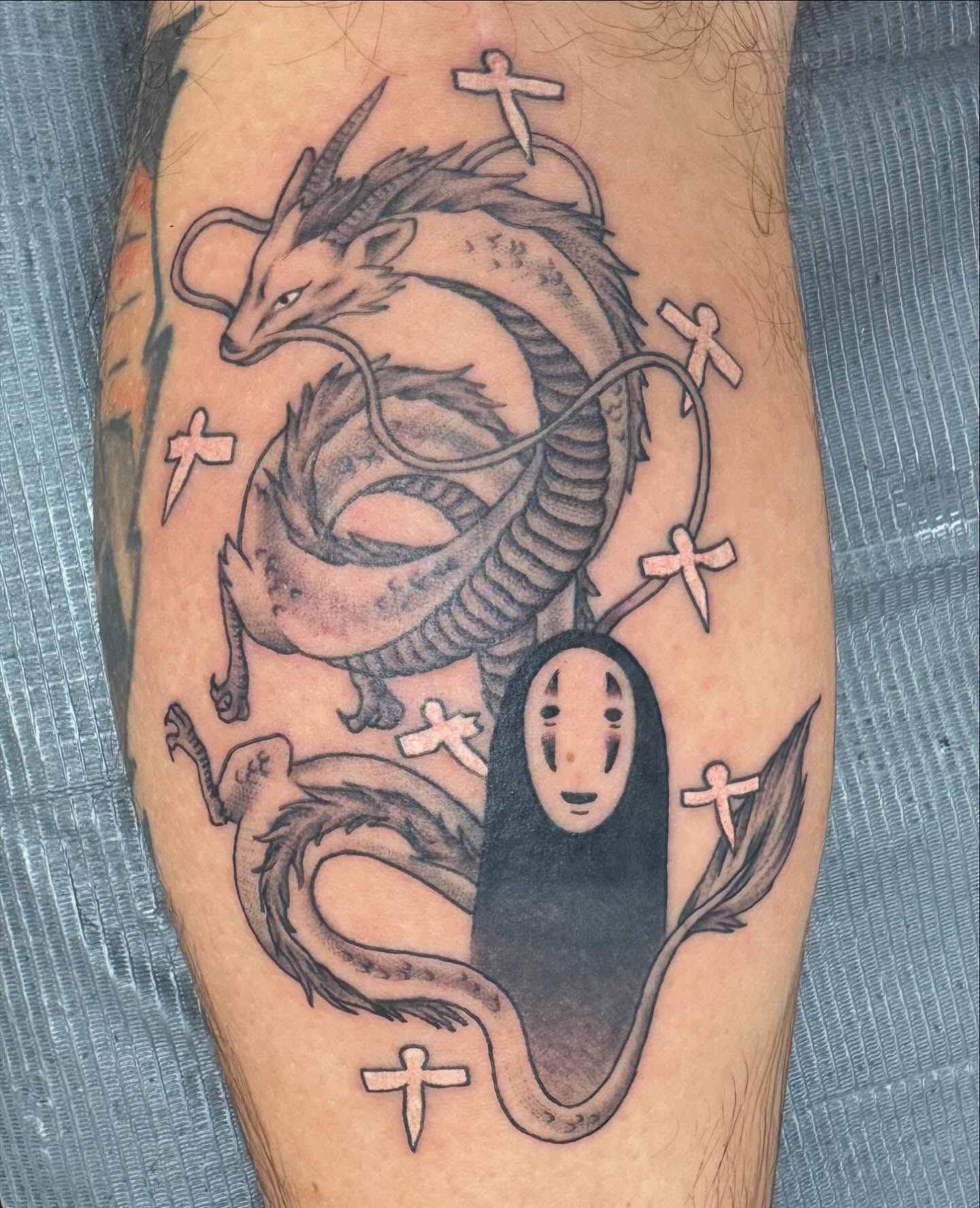 No face spirit and dragon anime tattoo on the forearm by McKenna Chalifoux