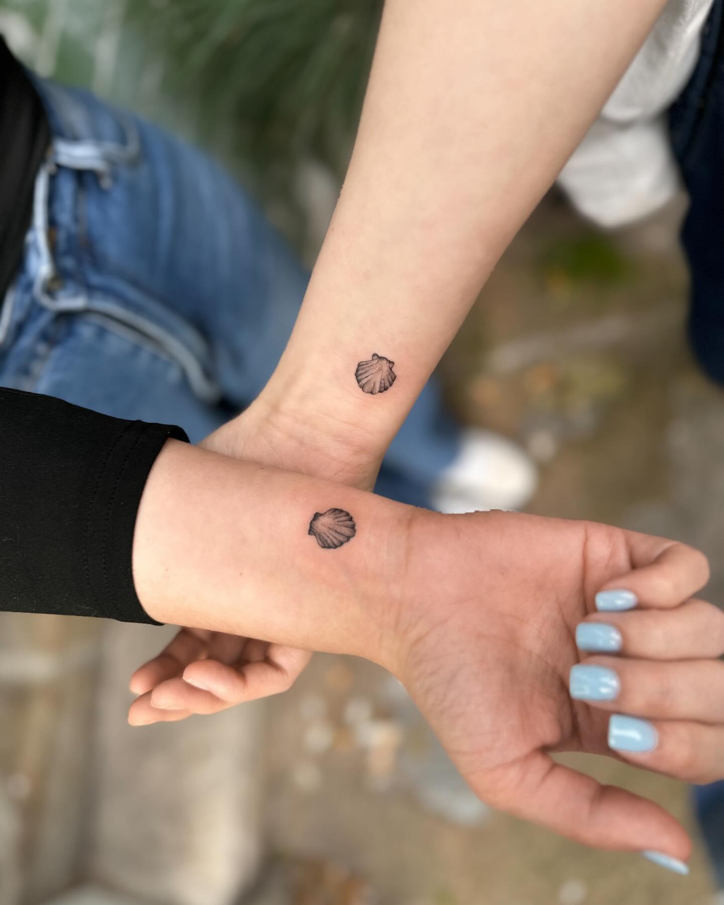 Shell minimalist tattoo on the forearm by Natasha Rachel Fineline Tattoos Nashville