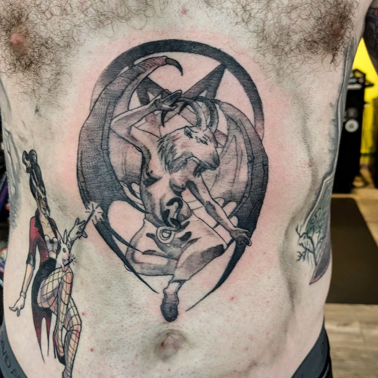 Demon and rabbit black and grey tattoo on the torso by Lahel (Lay-el) Fowler