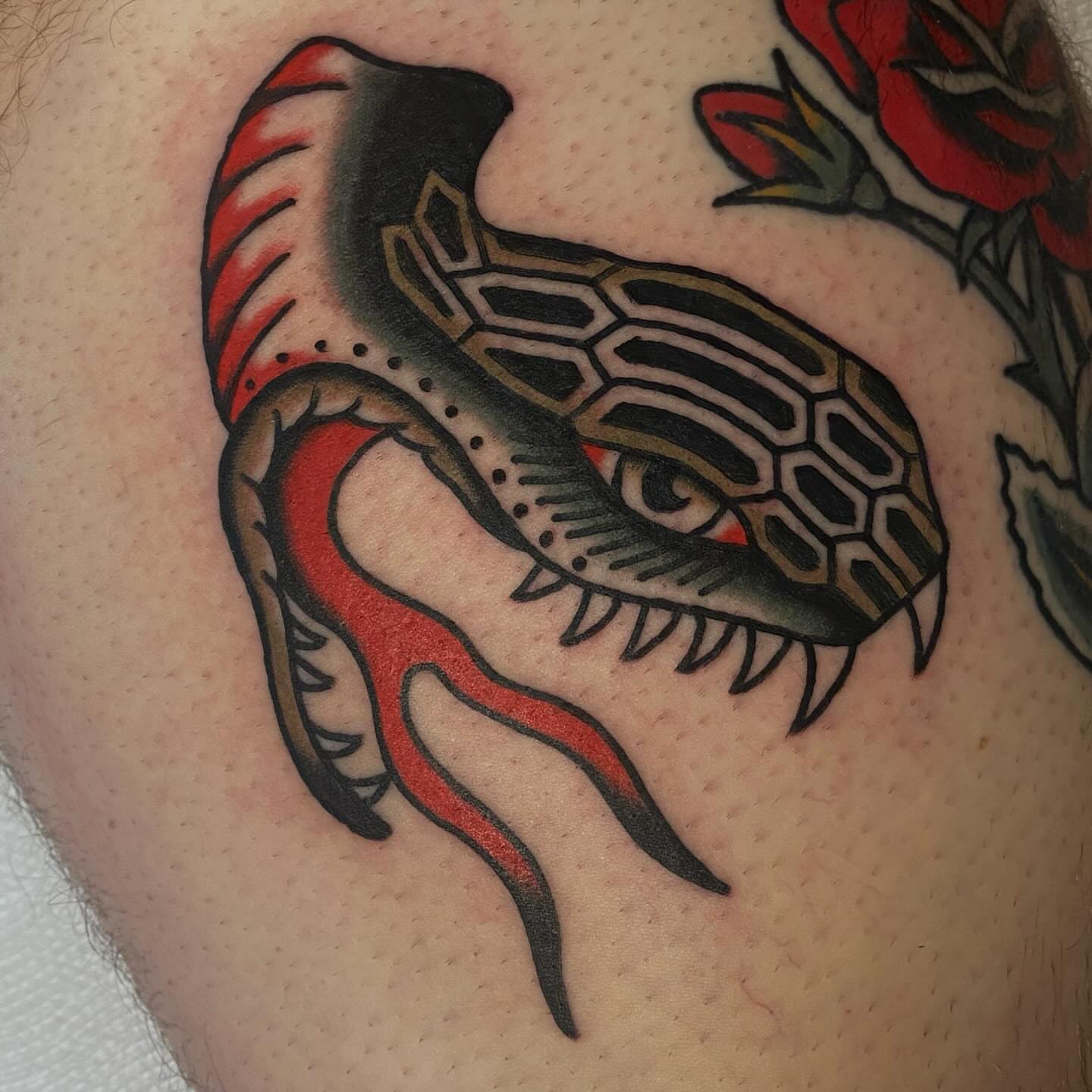 Snake American traditional tattoo on the thigh by Erin Chambers