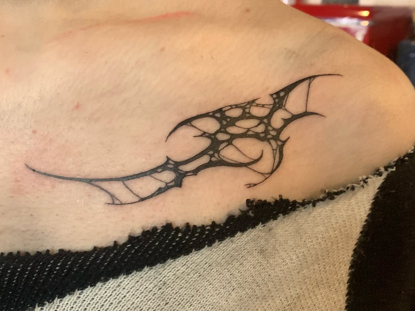 Geometric web geometric tattoo on the upper arm by Ava Glory Tattoos