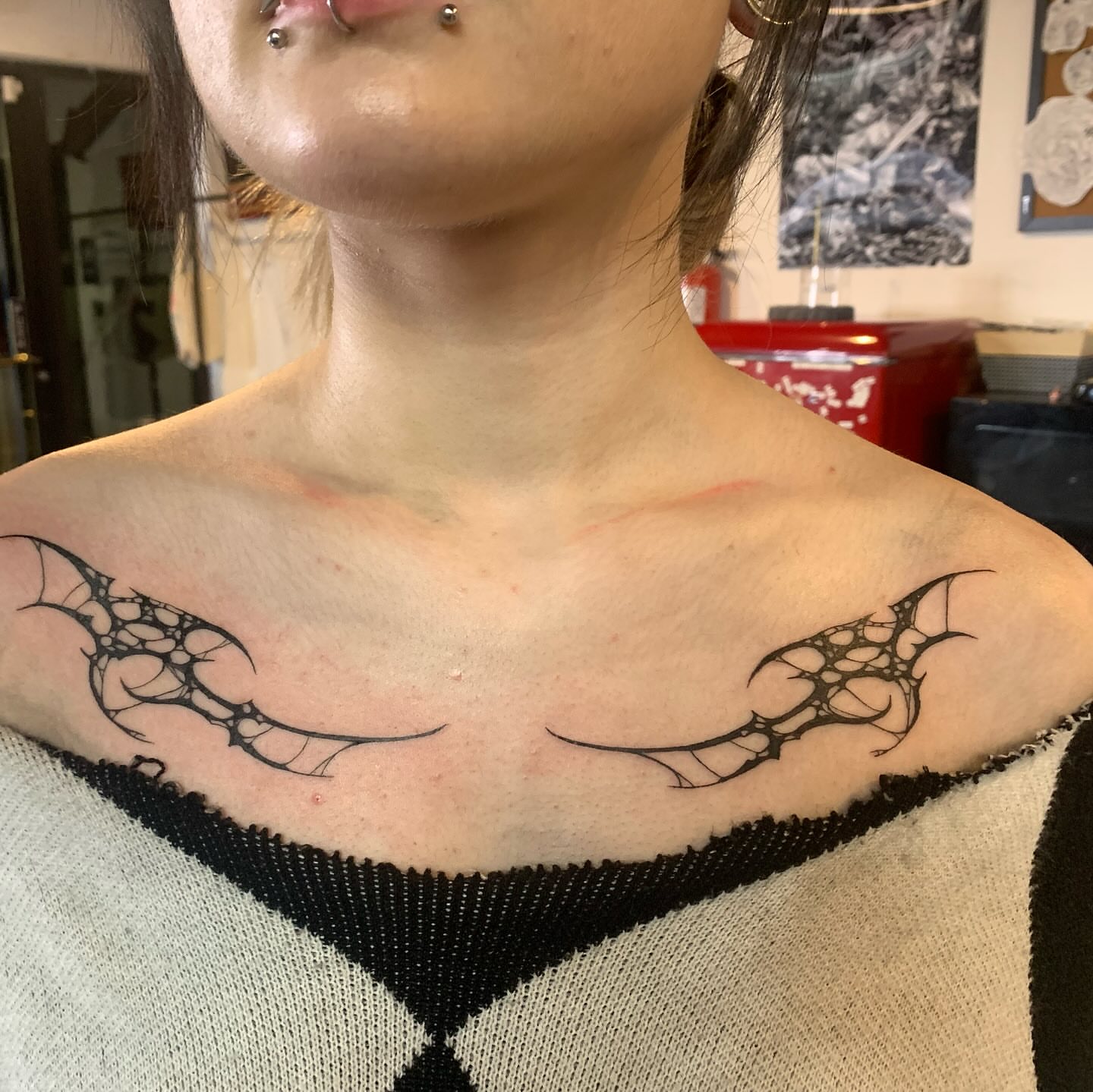 Spiderweb geometric tattoo on the chest by Ava Glory Tattoos