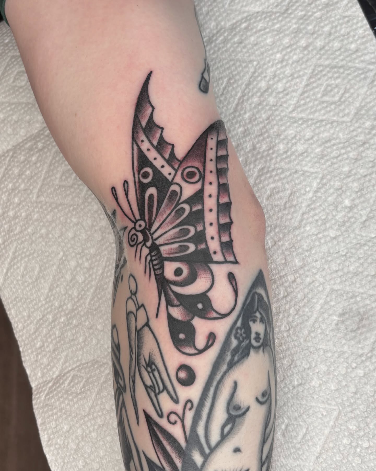 Butterfly black and grey tattoo on the forearm by Charlie Dunkel Tattoo