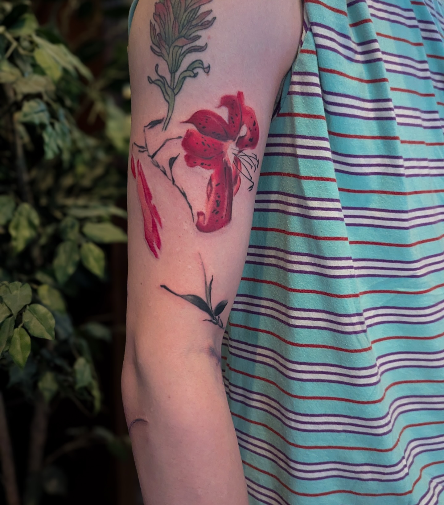 Lily watercolor tattoo on the forearm by Jhenn