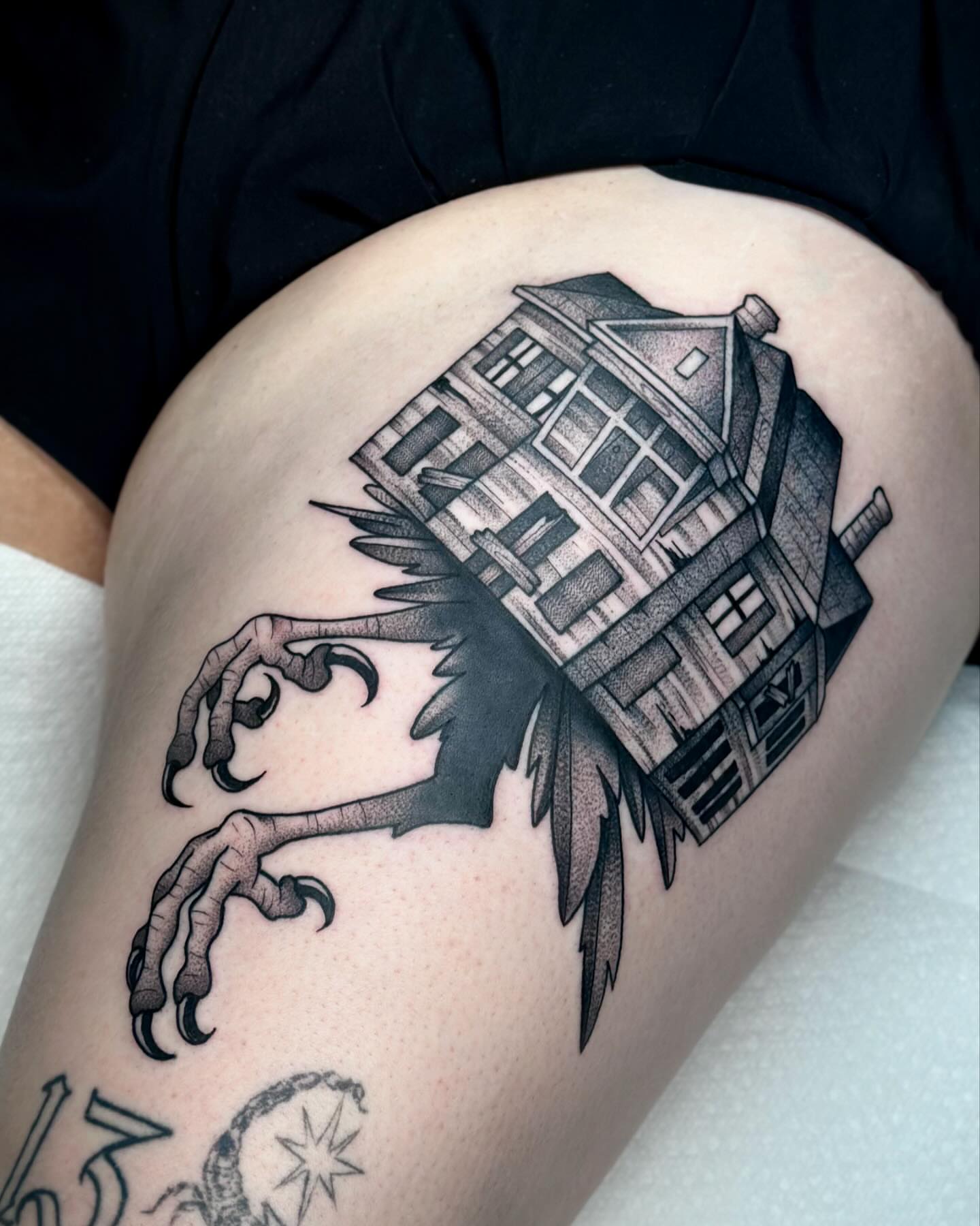 House with claw realism tattoo on the thigh by Katie Kelley