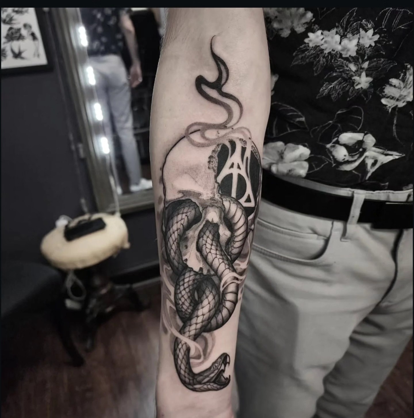Snake and skull realism tattoo on the forearm by Dani Ryan