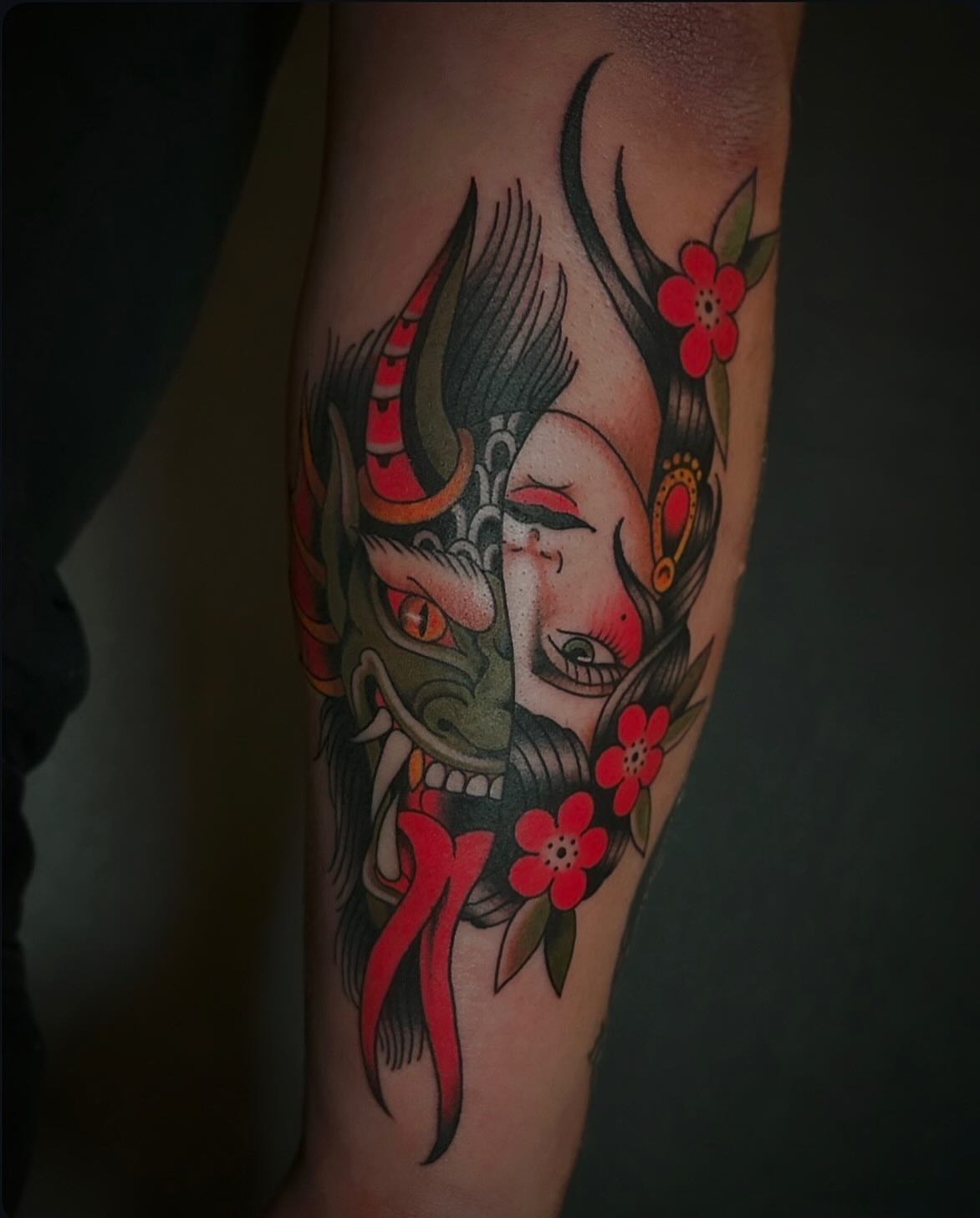 Geisha mask with flowers American traditional tattoo on the forearm by Kayla Shoffner