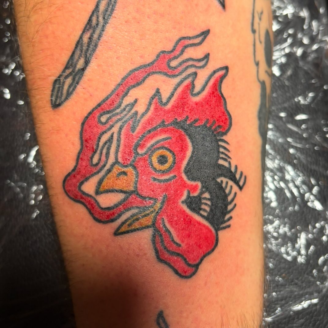 Rooster American traditional tattoo on the forearm by Natalie Opal🪻🍎🫖