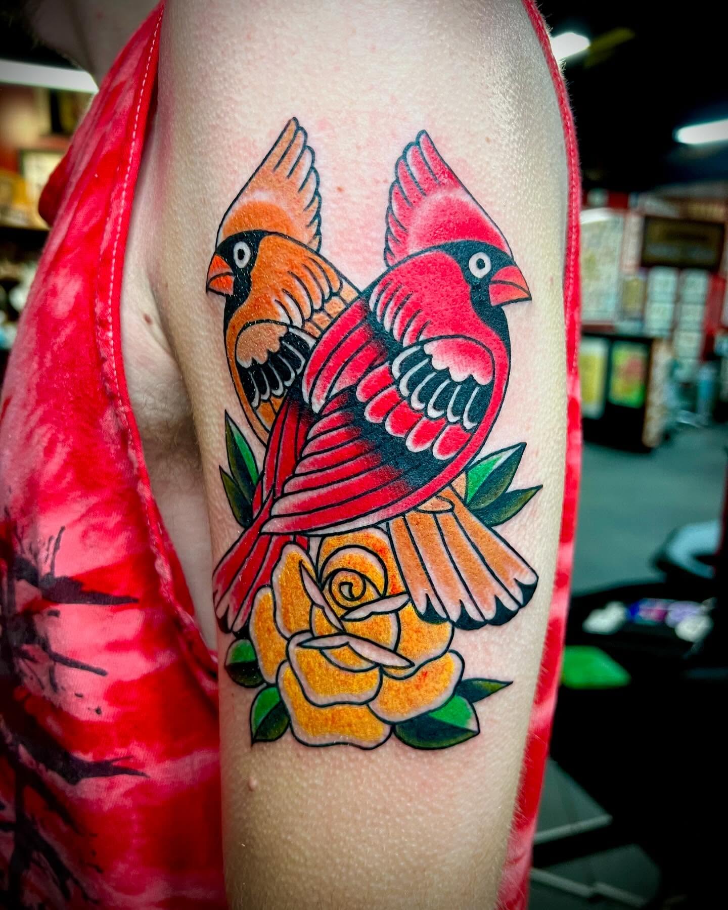 Cardinals and rose American traditional tattoo on the forearm by Dustin Hysell