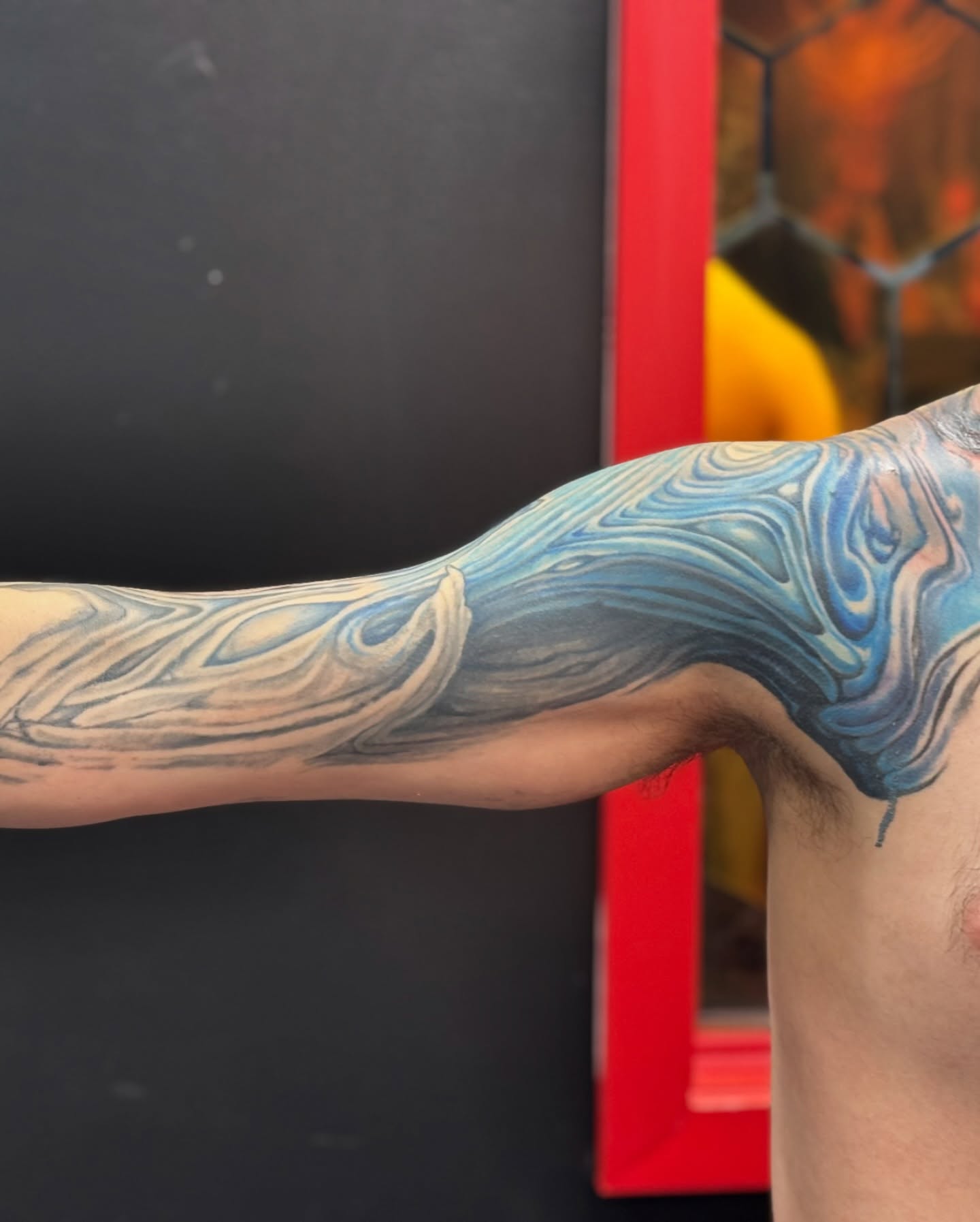 Abstract fluid design new school tattoo on the upper arm by Jordan Rookus