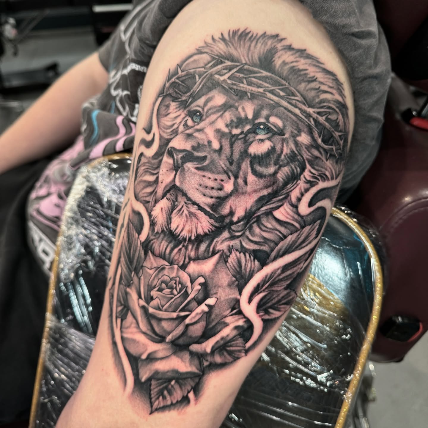 Lion with roses realism tattoo on the forearm by Ryan Futterman