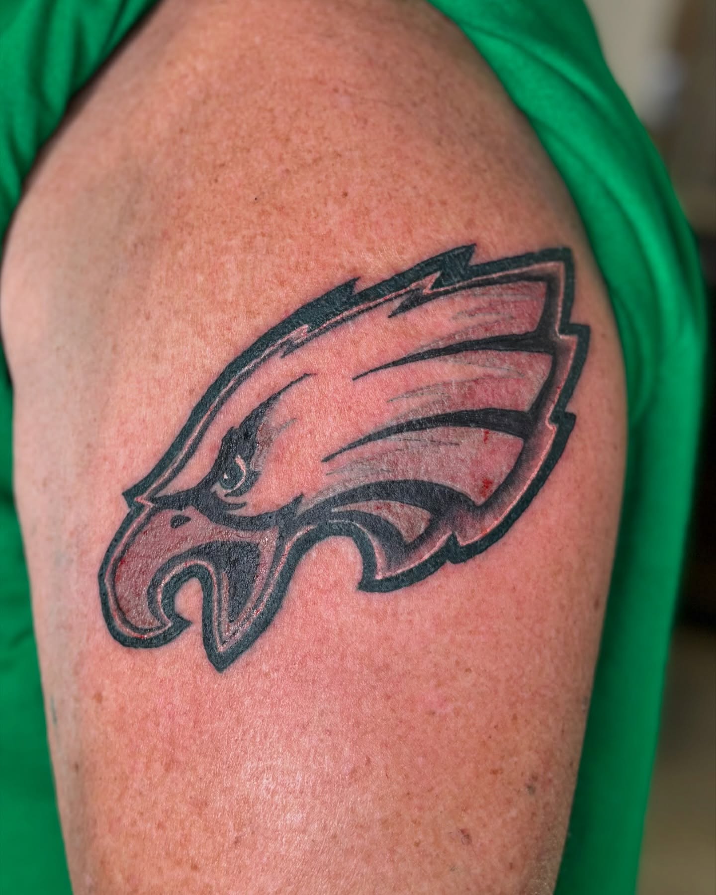 Philadelphia eagles logo black and grey tattoo on the shoulder by Bridget Smith