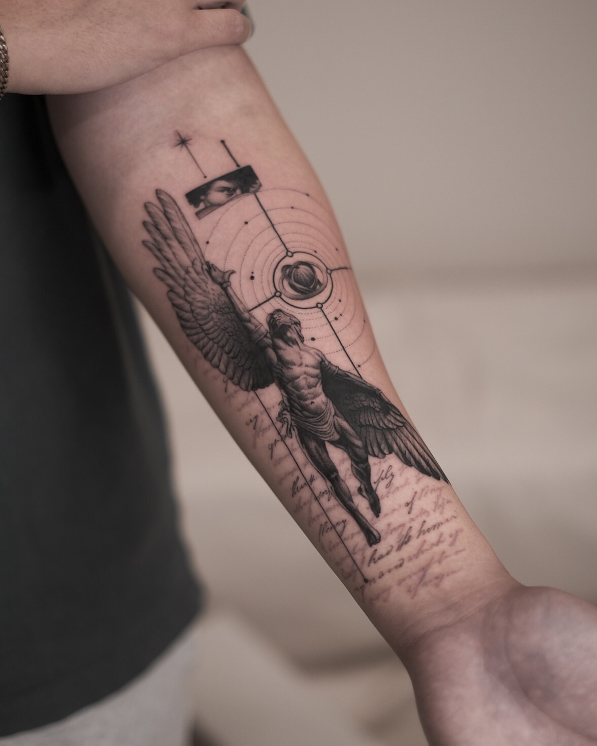 Angelic figure geometric tattoo on the forearm by Oleksandr Moroz