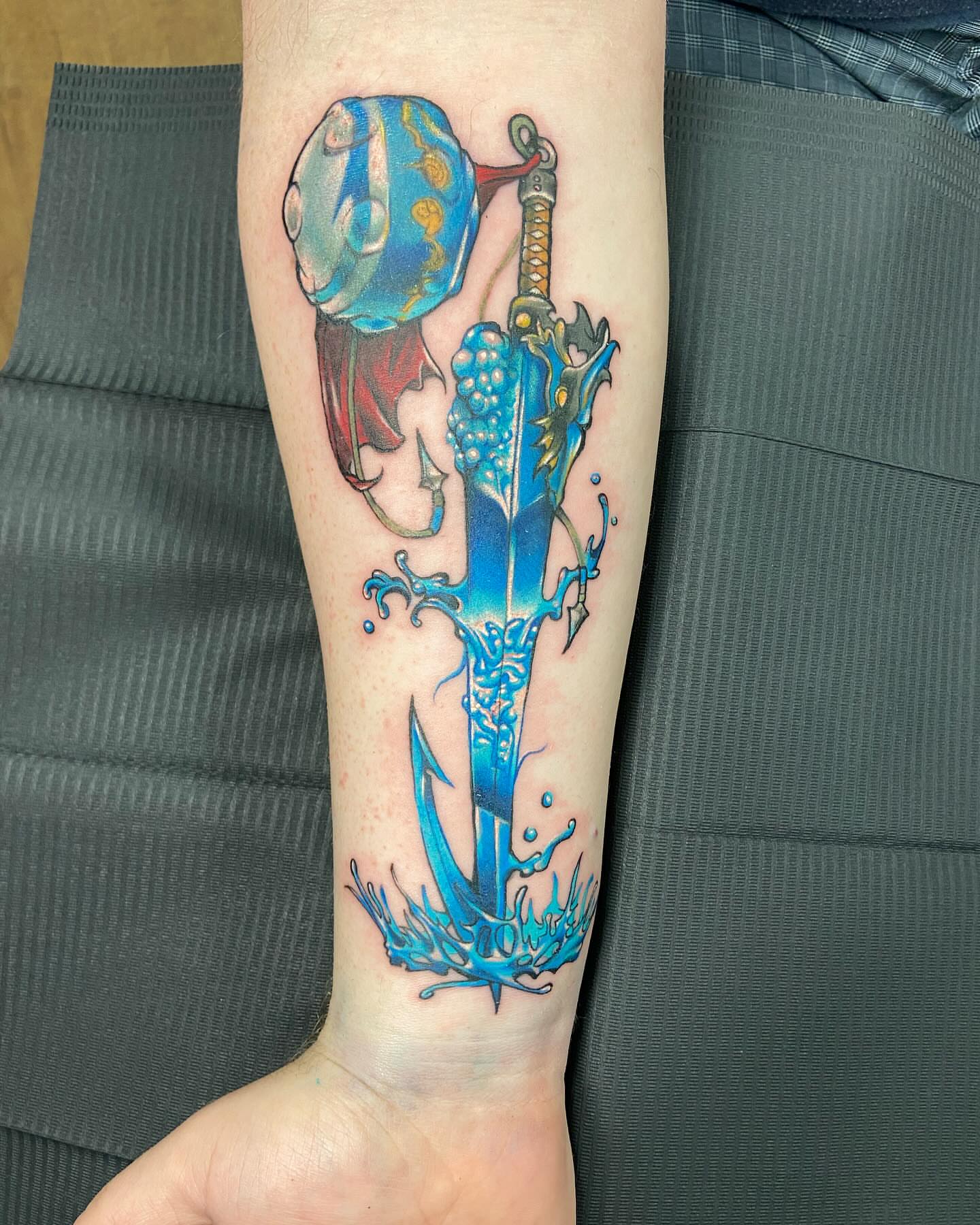 Sword and jellyfish new school tattoo on the forearm by Slade Nowicki