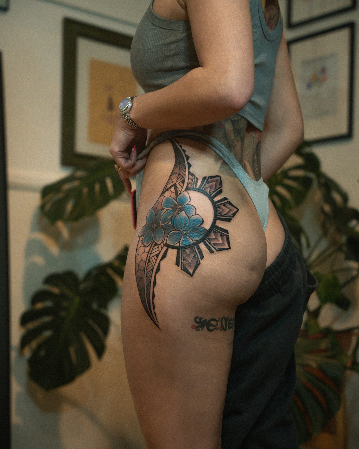 Sun and flowers tribal tattoo on the thigh by Christopher Espino, Hawthorne, California