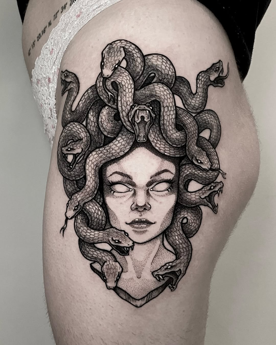 Medusa dotwork tattoo on the thigh by Rowan Starr
