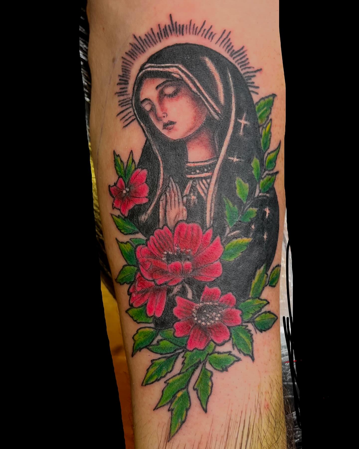 Religious figure with flowers American traditional tattoo on the forearm by Bobby Glennon