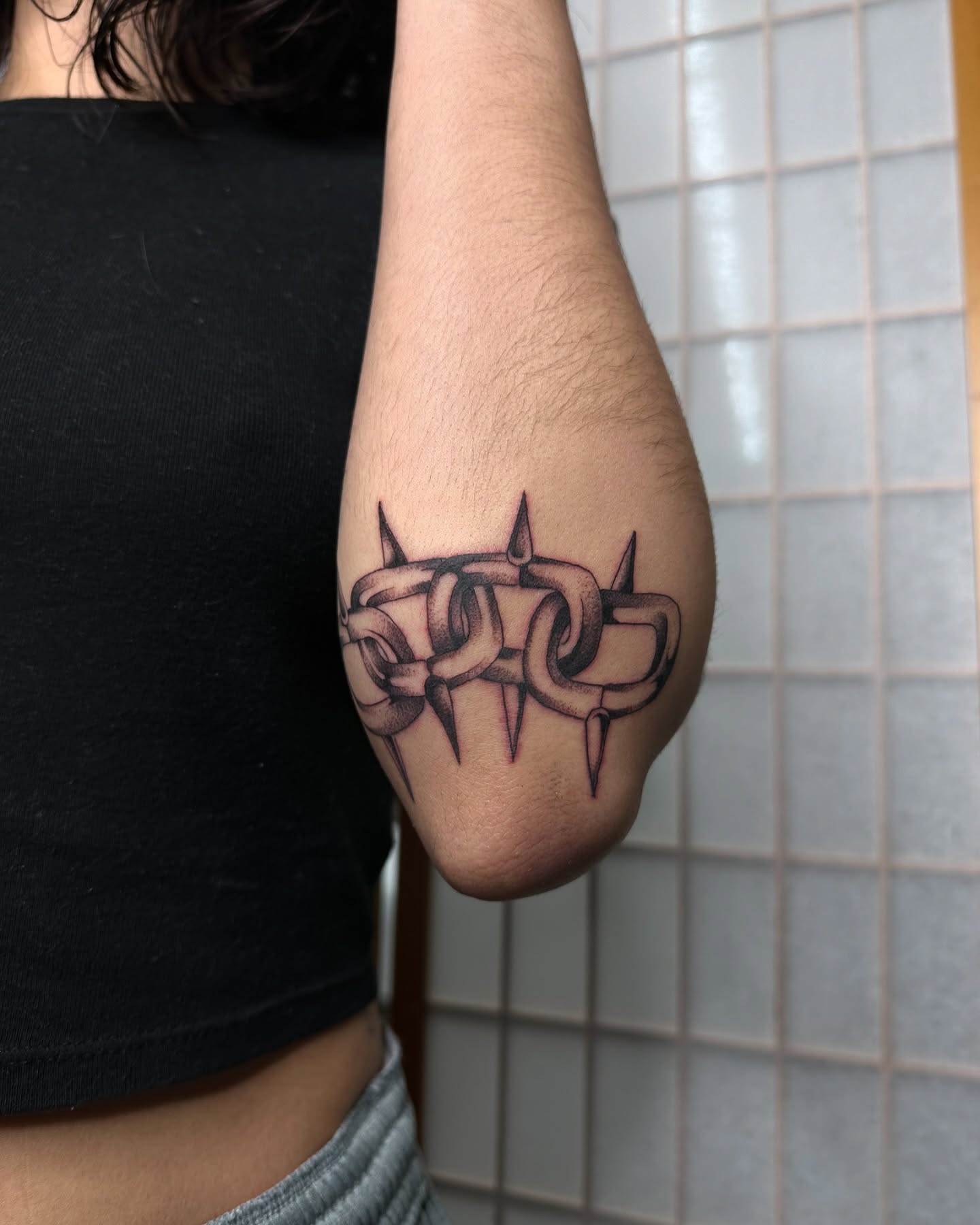 Barbed wire black and grey tattoo on the forearm by christian martinez