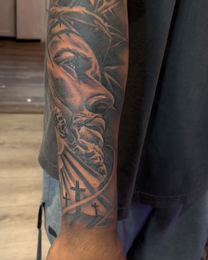 Religious figure black and grey tattoo on the forearm by michael