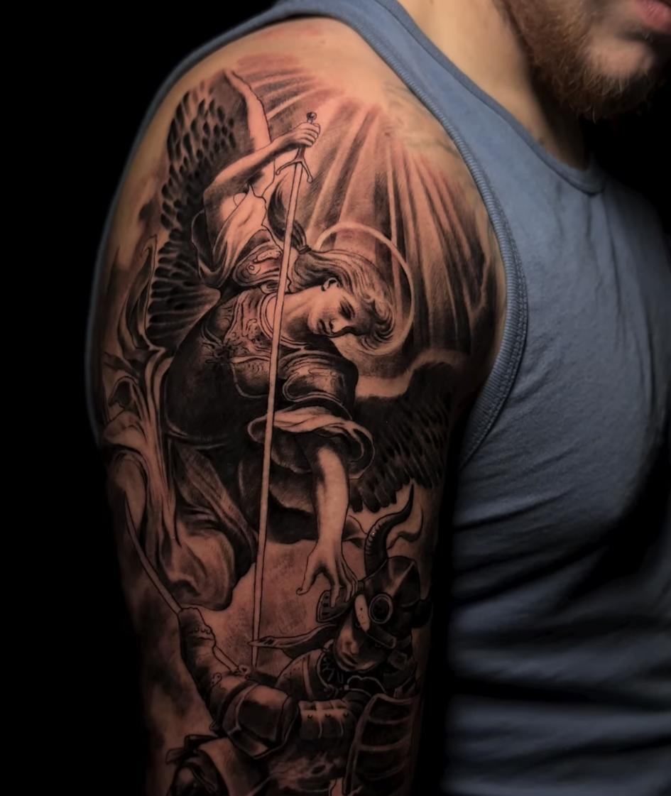 Angel with sword realism tattoo on the upper arm by Dark Shadows Tattoo
