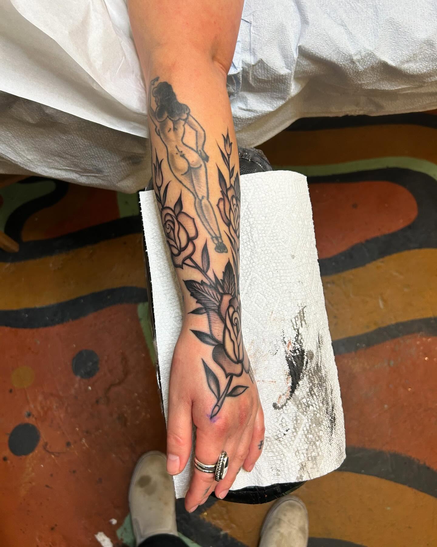 Nude woman with roses black and grey tattoo on the forearm by Sam Perry, Denver, Colorado