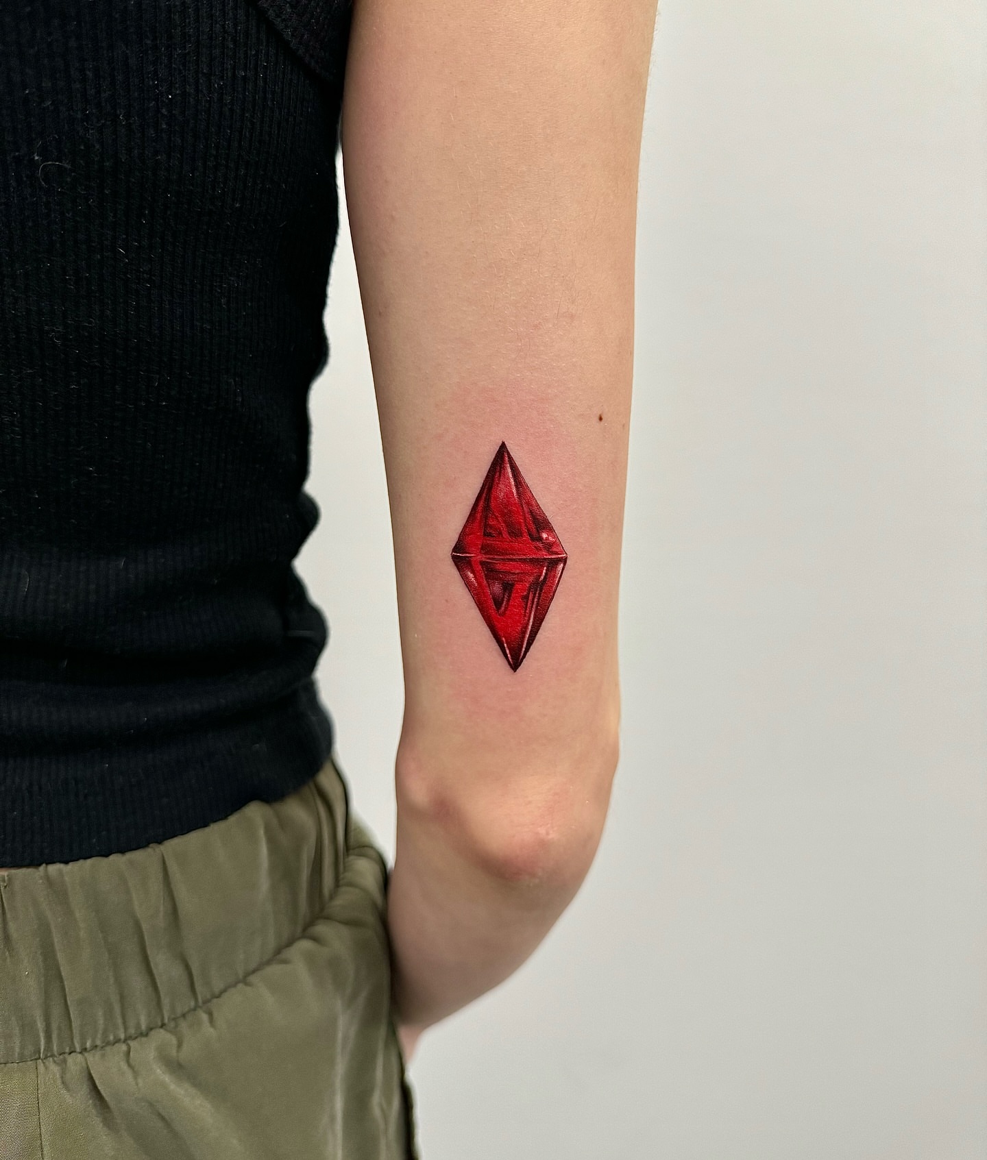 Red gem geometric tattoo on the forearm by ηυñєzιηкz, Kansas City, Missouri