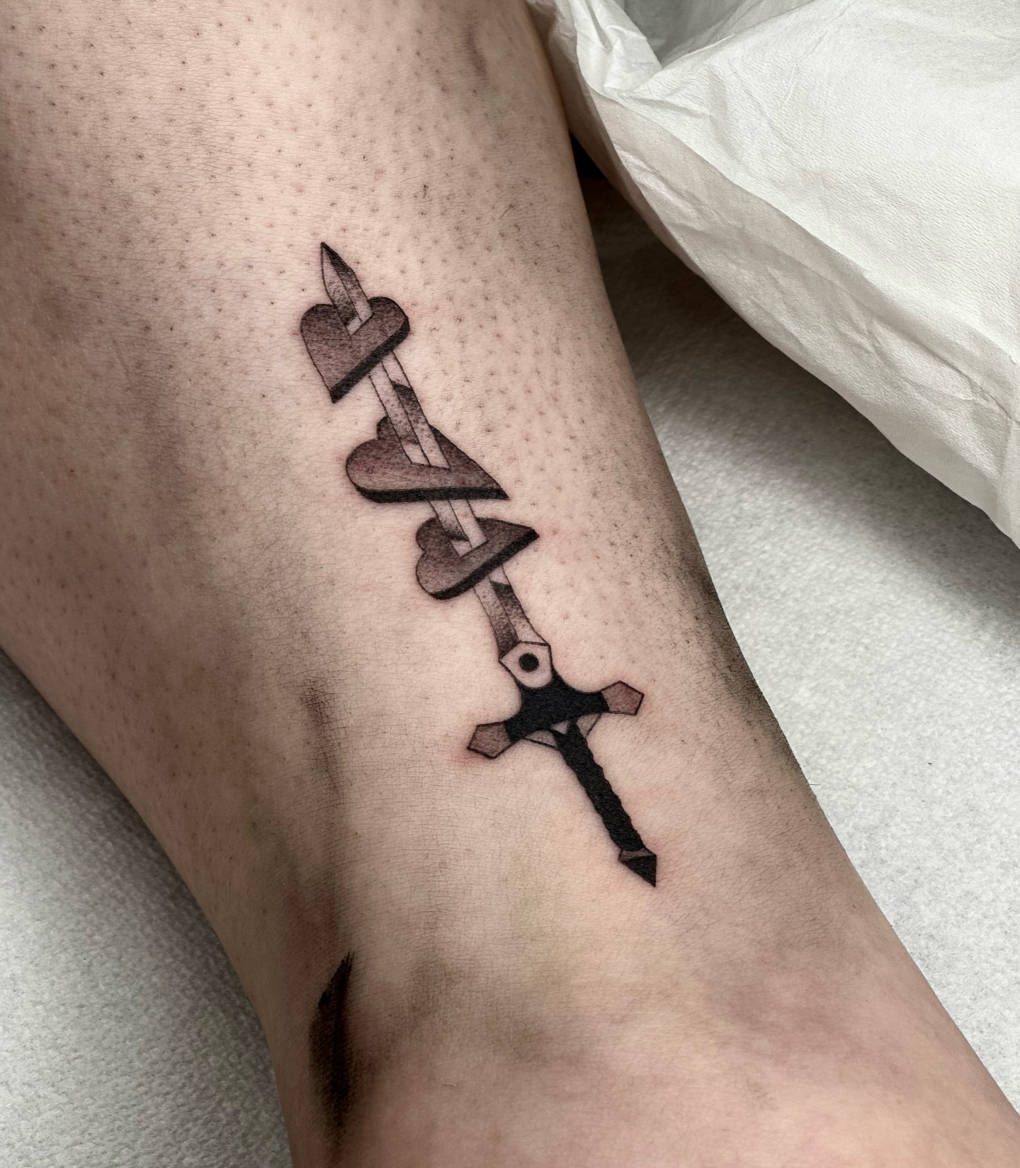 Cross and hearts black and grey tattoo on the forearm by Maks