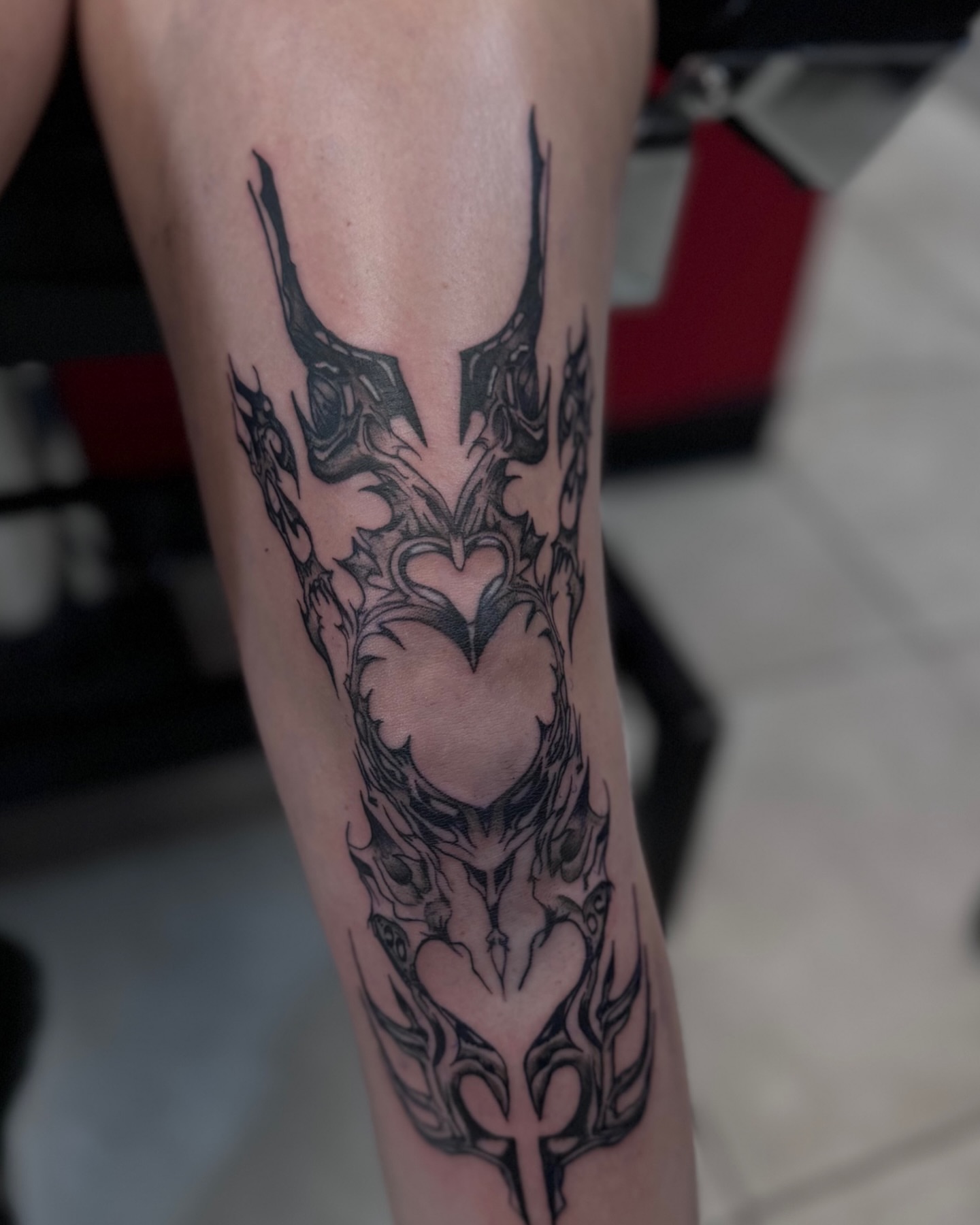 Heart with horns black and grey tattoo on the forearm by Honey